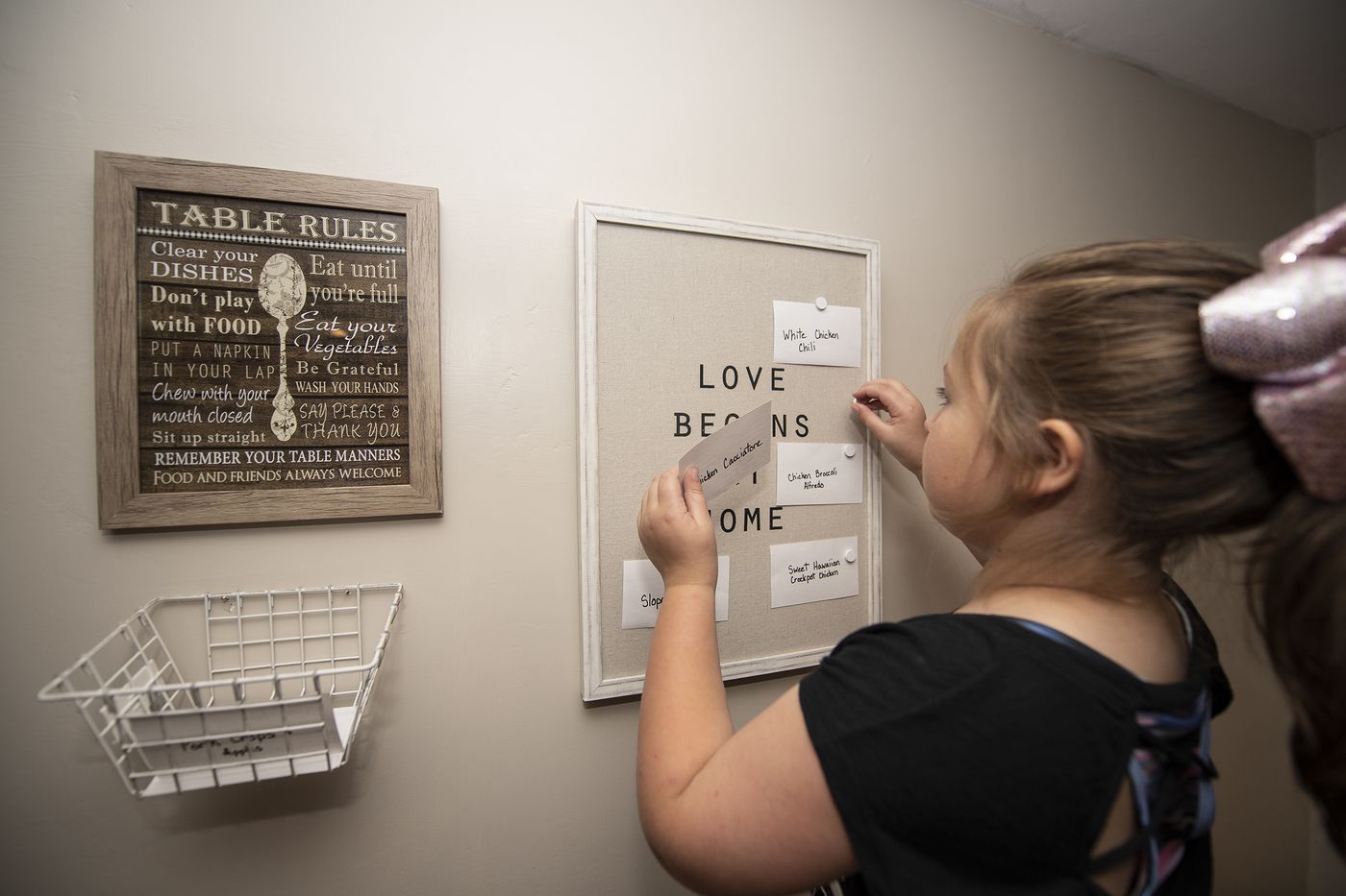 Grace Edwards, 6, organizes her dinner note cards at her home in Springfield, Delaware County.