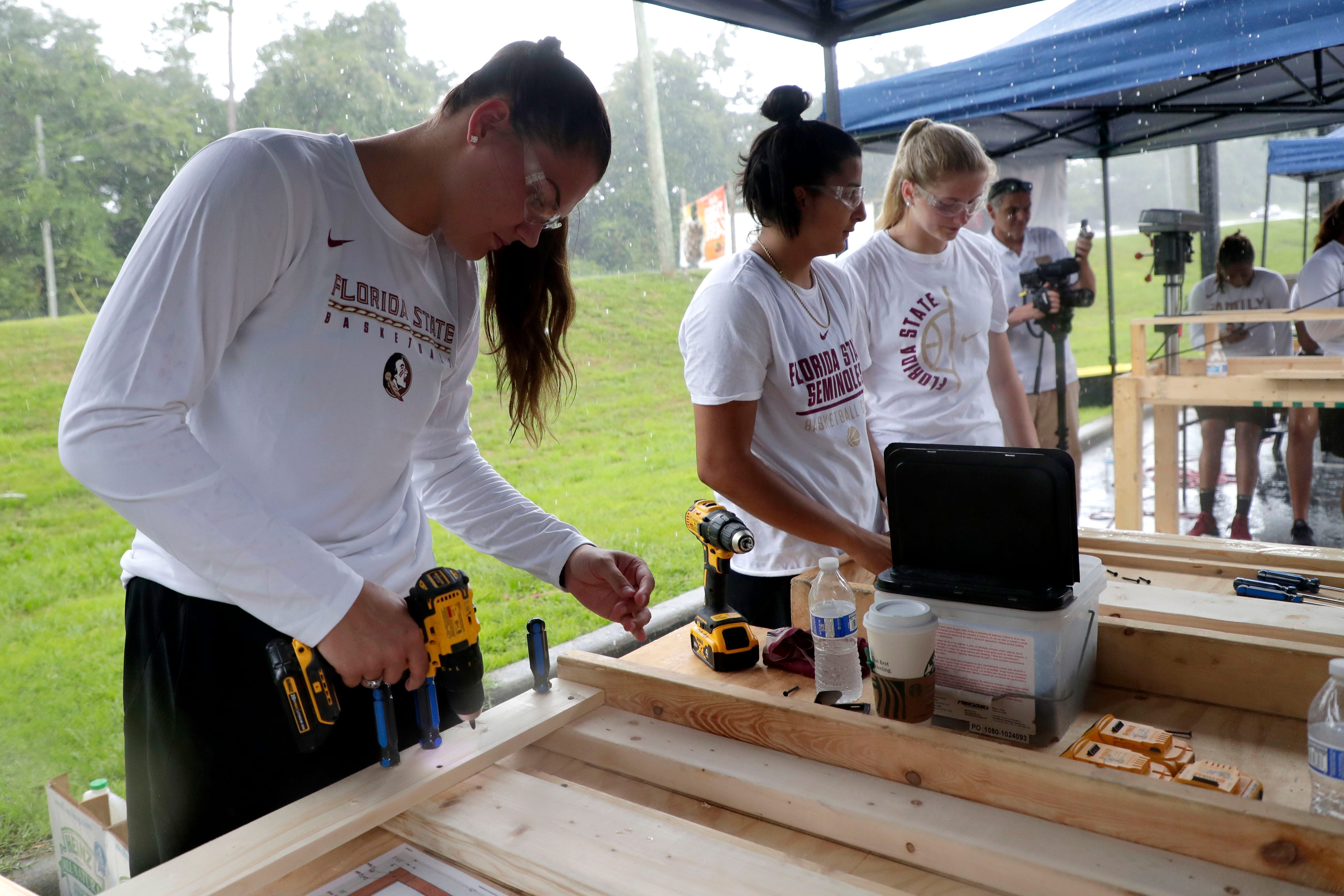 River Baldwin, a member of the Florida State women's basketball team, works alongside her teammates to build bunk beds for children in the Big Bend. FSU women's basketball teamed up with Texas Roadhouse and other volunteers to complete the project Tuesday, July 23, 2019. 