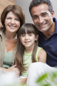 Grandparents with granddaughter at home