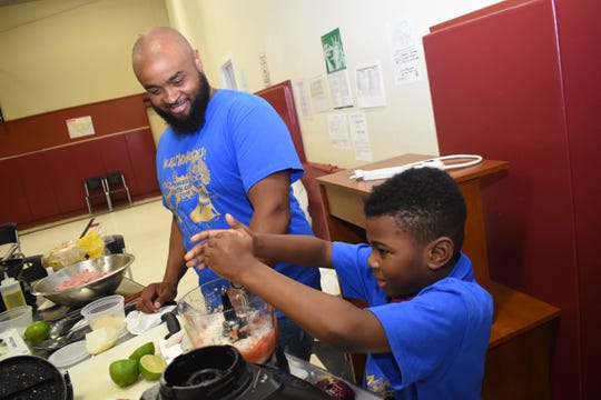 John Belvin Jr., executive chef at the Diamond Grill, watches Dorian Hinkston as he squeezes lime juice into a batch of homemade salsa. Belvin was the guest speaker at the Healthy Heroes Camp sponsored and coordinated by the Pineville Rotary Club and the Pineville Youth Center. He taught the campers how to make turkey tacos, homemade salsa and homemade guacamole.
