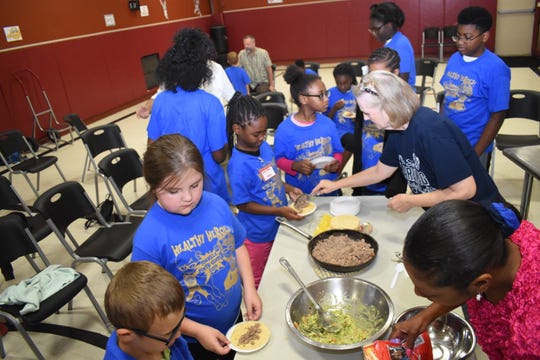 The Healthy Heroes Camp, sponsored and coordinated by the PIneville Rotary Club along with the Pineville Youth Center, concluded the four-day camp Thursday, July 11, 2019. "We have about 70 children that registered for the camp," said Christy Frederic, a charter member of the club. Campers were treated to lunch and a program. On Thursday, John Belvin Jr., executive chef of the Diamond Grill, taught the campers how to make Turkey Tacos. "Today I chose to do some ground turkey tacos with some corn tortillas, homemade guacamole, homemade salsa - just trying to show the kids that it's not boring to eat healthy," said Belvin. The recipe is simple and the children can make at home. Belvin also shared his experiences in the culinary field and his life with the campers. Dorian Hinkston, 6 - but will "turn 7 in a few days" - was Belvin's helper. He helped sprinkle the seasoning on the ground turkey and said he liked the taste of the seasoning. Dorian said he wanted to be a chef when he grew up. "Because I want people to like my food that I make," he explained. 