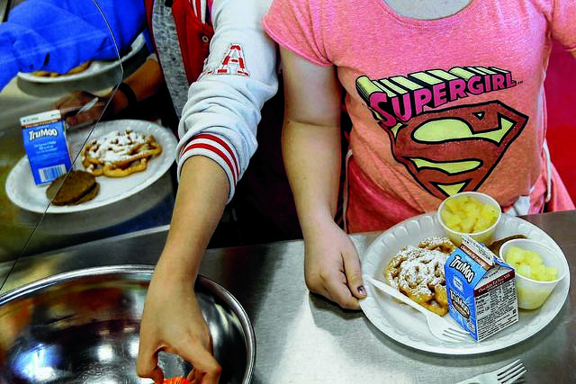FILE - In this Friday, May 19, 2017 file photo, students line up for lunch at a middle school in Sandy, Utah. New York has joined five other states and the District of Columbia that have sued the Department of Agriculture, accusing the federal agency of weakening nutritional standards in school meals.The lawsuit was filed on Wednesday, April 3, 2019 in Manhattan federal court. (Laura Seitz/The Deseret News via AP)AP file photo