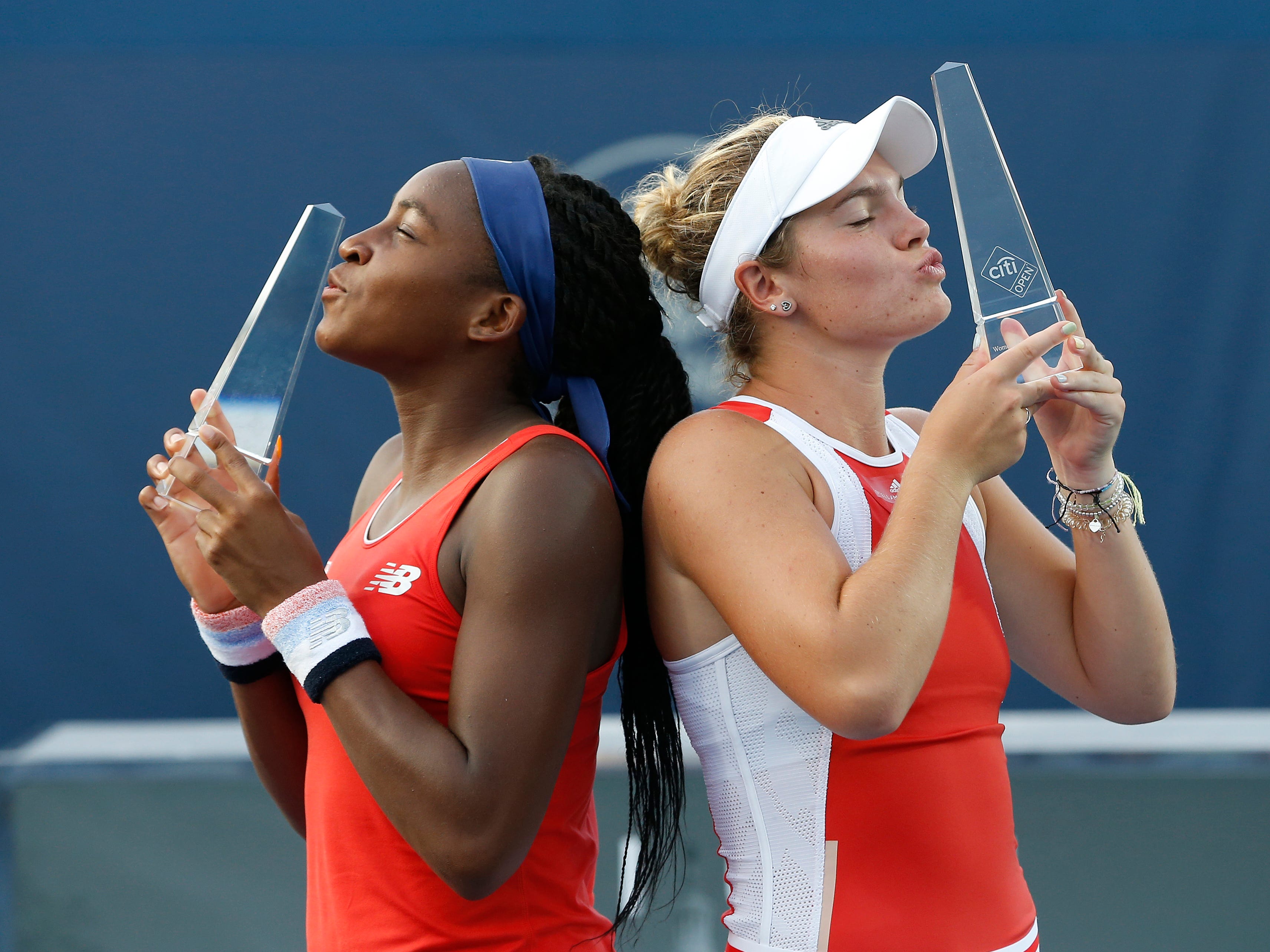 Coco Gauff and Catherine Mcnally pose with their trophies after the women's doubles final at the 2019 Citi Open.