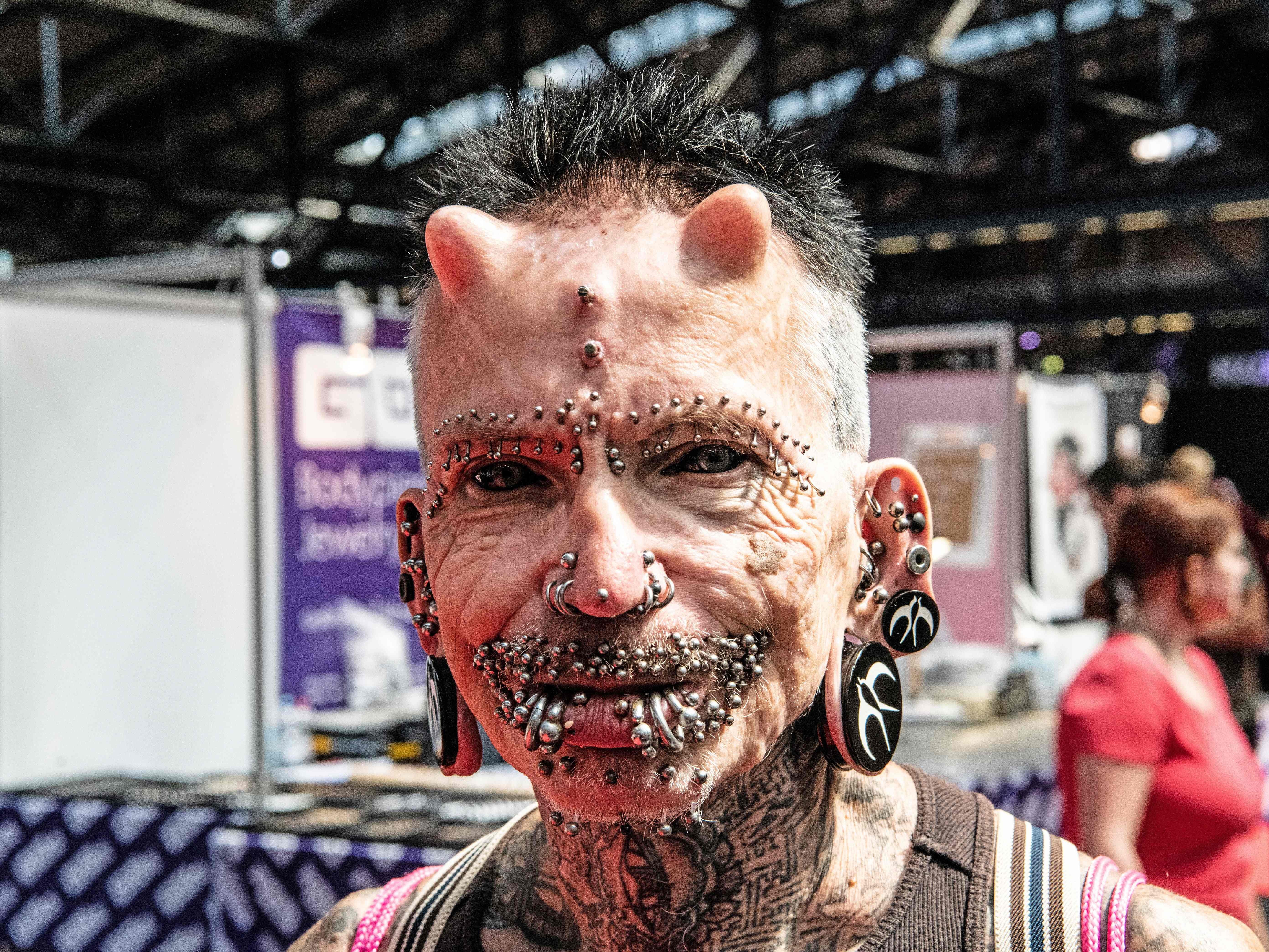 Piercing model Rolf Buchholz poses on Aug. 3, 2019 at the Tattoo Convention fair in Berlin. Buchholz has more than 500 body modifications and therefore holds an entry in the Guinness World Records.