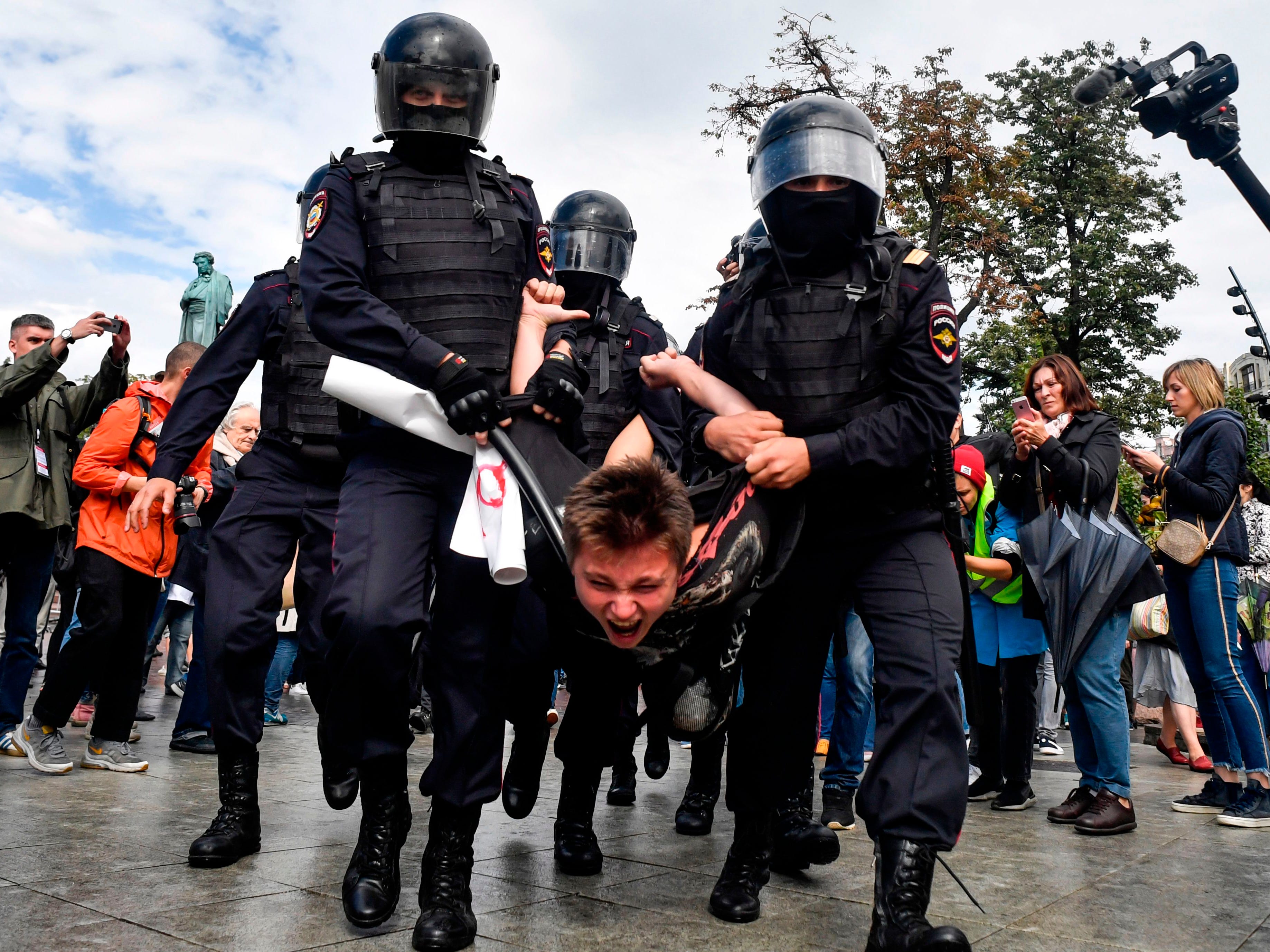 Riot police officers detain a participant of an unsanctioned rally urging fair elections at Moscow's Pushkinskaya Square on Aug. 3, 2019. The rally is the latest in a series of demonstrations after officials refused to let popular opposition candidates run in next month's city parliament elections. 