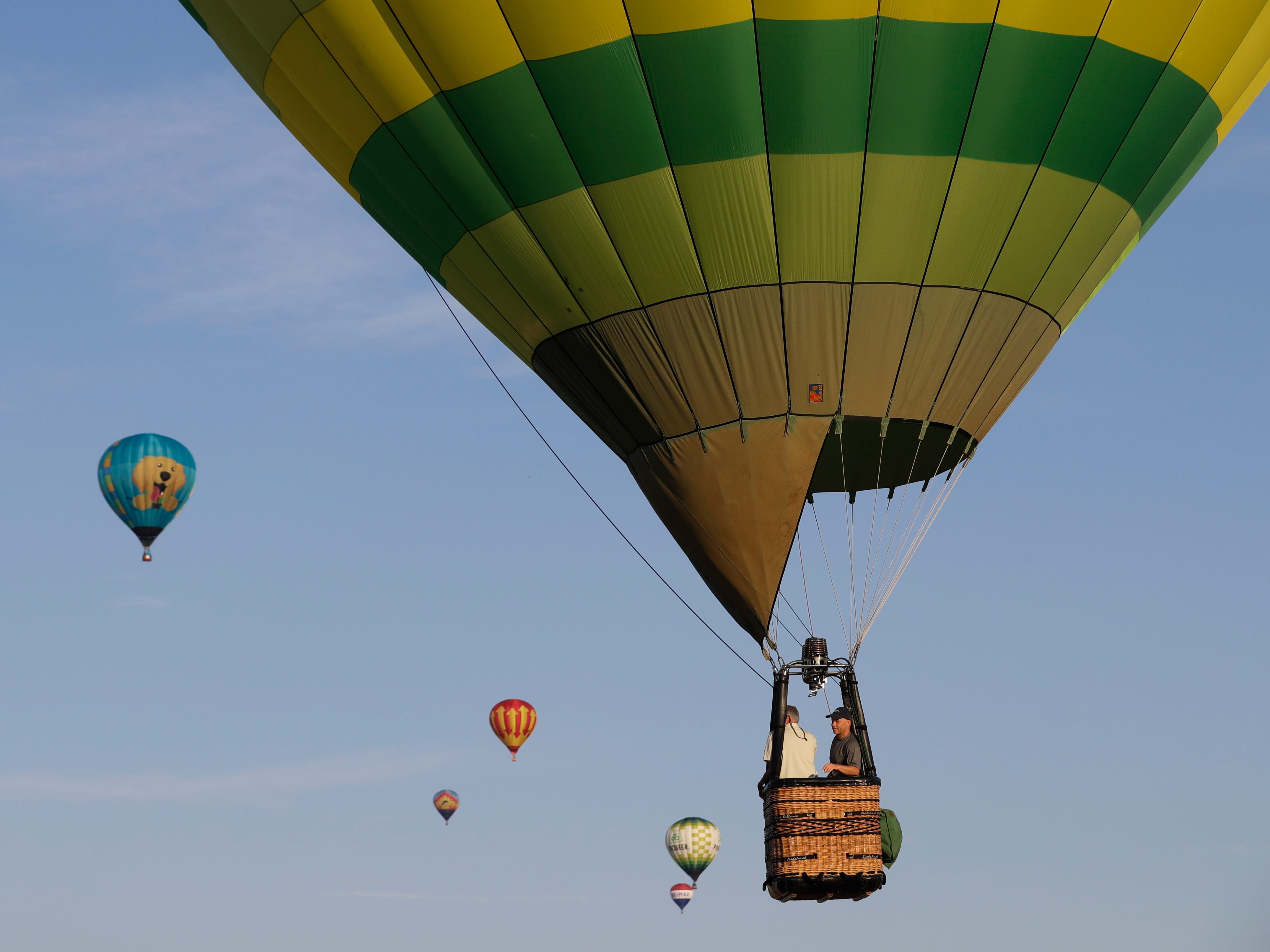 Hot air balloons fly during the Indiana State Fair hot air balloon race, Saturday, Aug. 3, 2019, in Indianapolis. The fair runs through Sunday, Aug. 18th. 