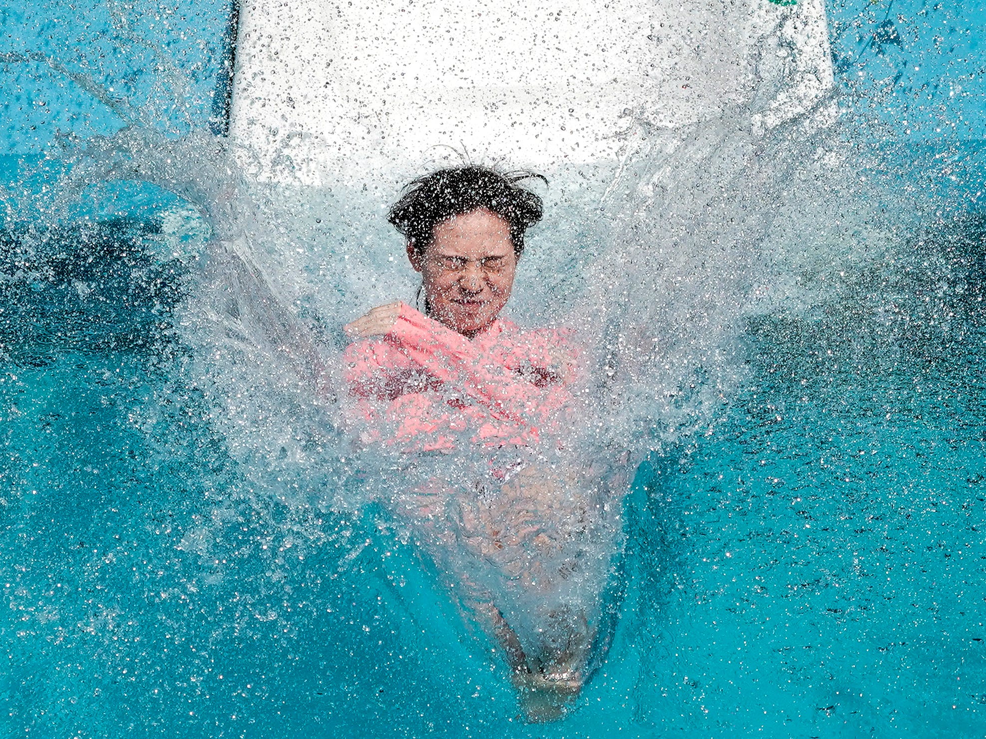 A visitor dives into the water from a water slide at a pool of Toshimaen amusement park at Nerima in Tokyo, Japan on Aug. 3, 2019. The highest temperature at Nerima rose into 36.2 degrees centigrade. In Kurume, southwestern Japan, the temperature marked 38.4 degrees, highest temperature of the day in the country. 
