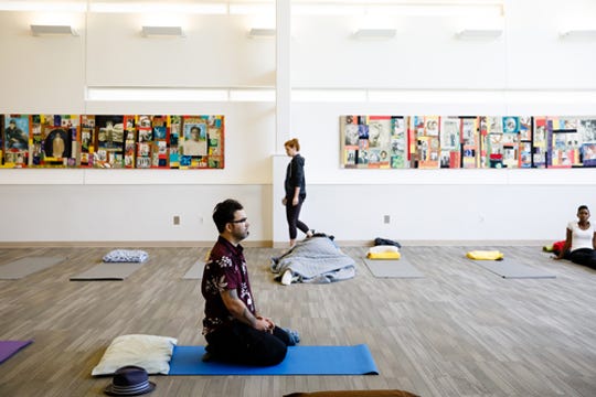 8/4/19 3:09:22 PM -- Atlanta, GA -- Michael Haverty (left) and Brittany Ranew attend an event organized by he Atlanta-based Nap Ministry which recognizes the power of rest and is working to raise awareness of sleep deprivation as a social justice issue. They invite people to collectively nap at their events, with yoga mats, pillows, music and blankets. -- Photo by Dustin Chambers, Freelance ORG XMIT: DC 138173 Nap Ministry 08/04/2019 [Via MerlinFTP Drop]
