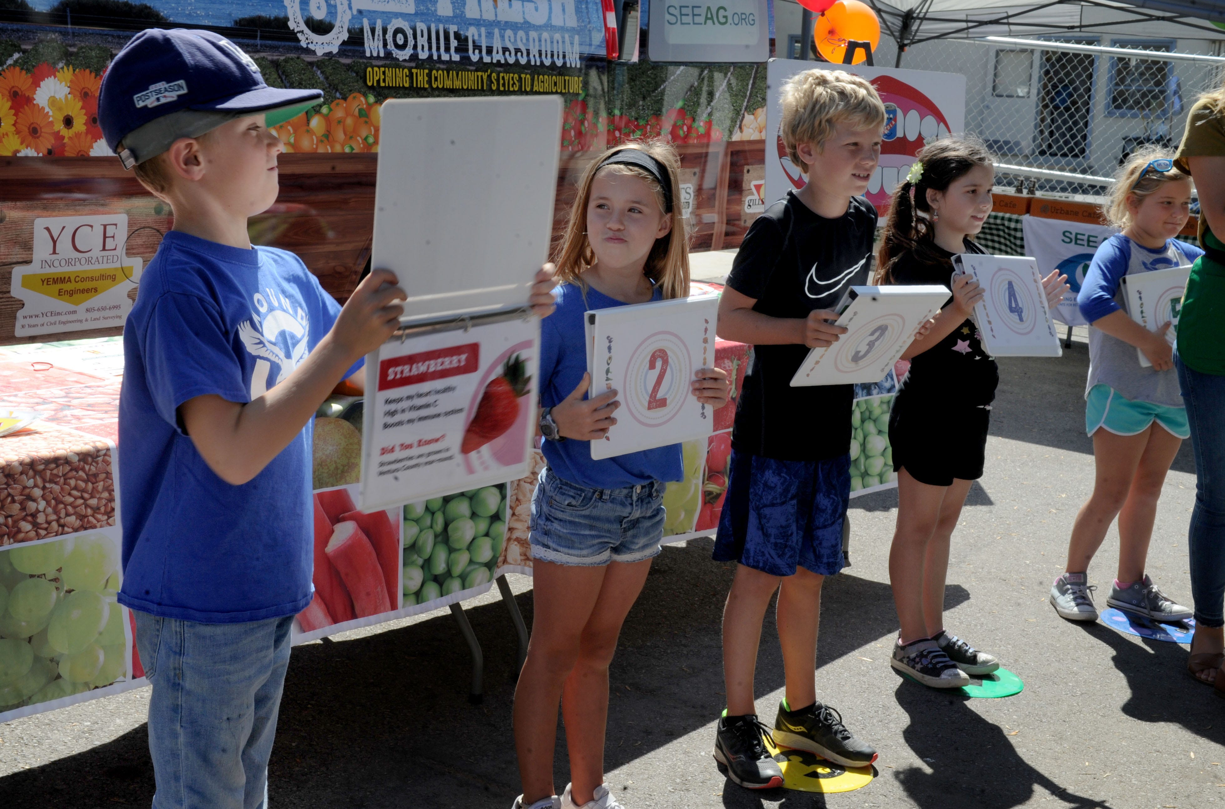 Mason McPherson, left, participates in an activity as Lucca Mangone looks on when Students for Eco-Education and Agriculture’s mobile classroom came to Mound School.