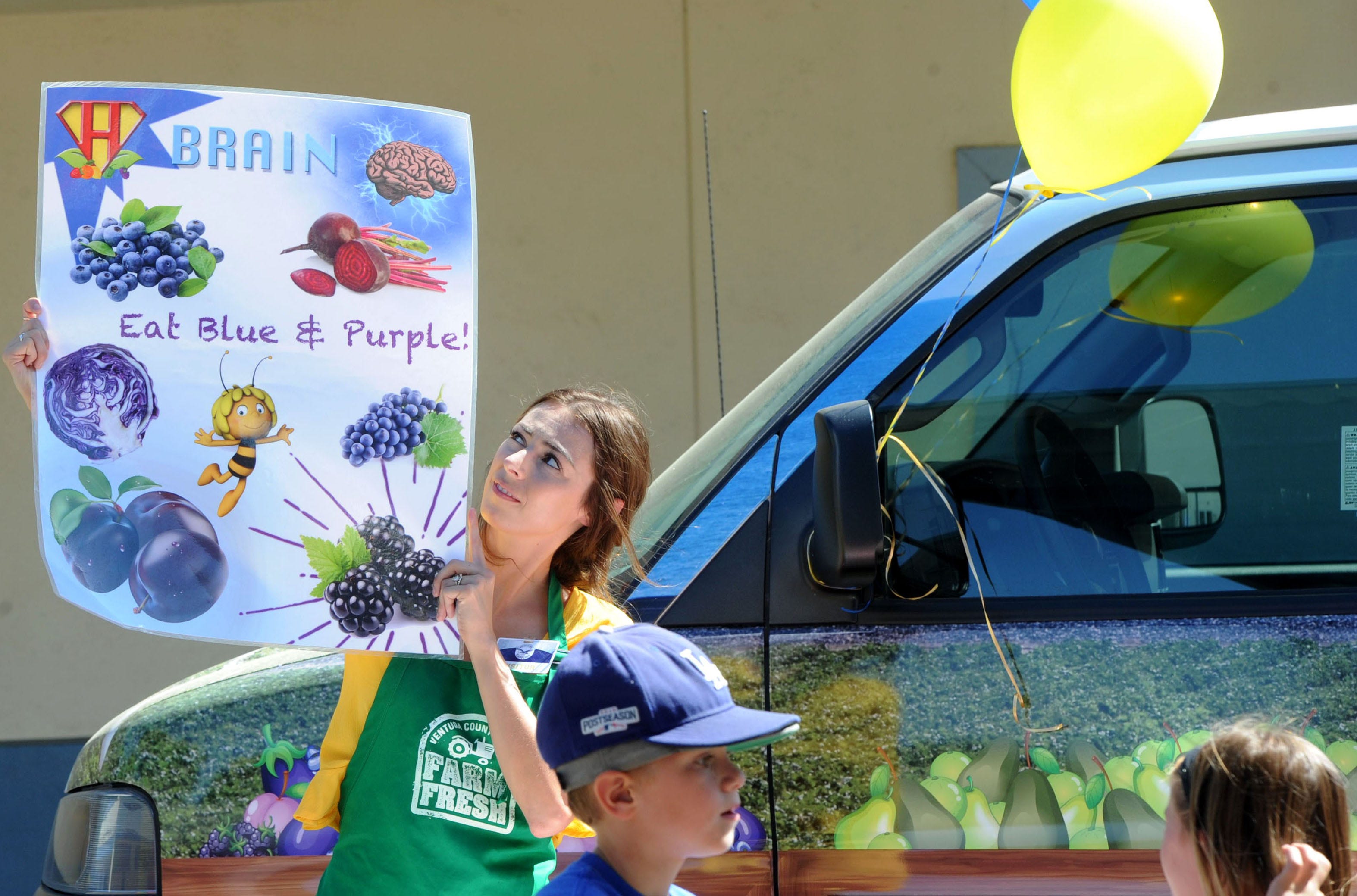 Caitlin Case of Students for Eco-Education and Agriculture works with students when the nonprofit's mobile classroom paid a visit to Mound School in Ventura.