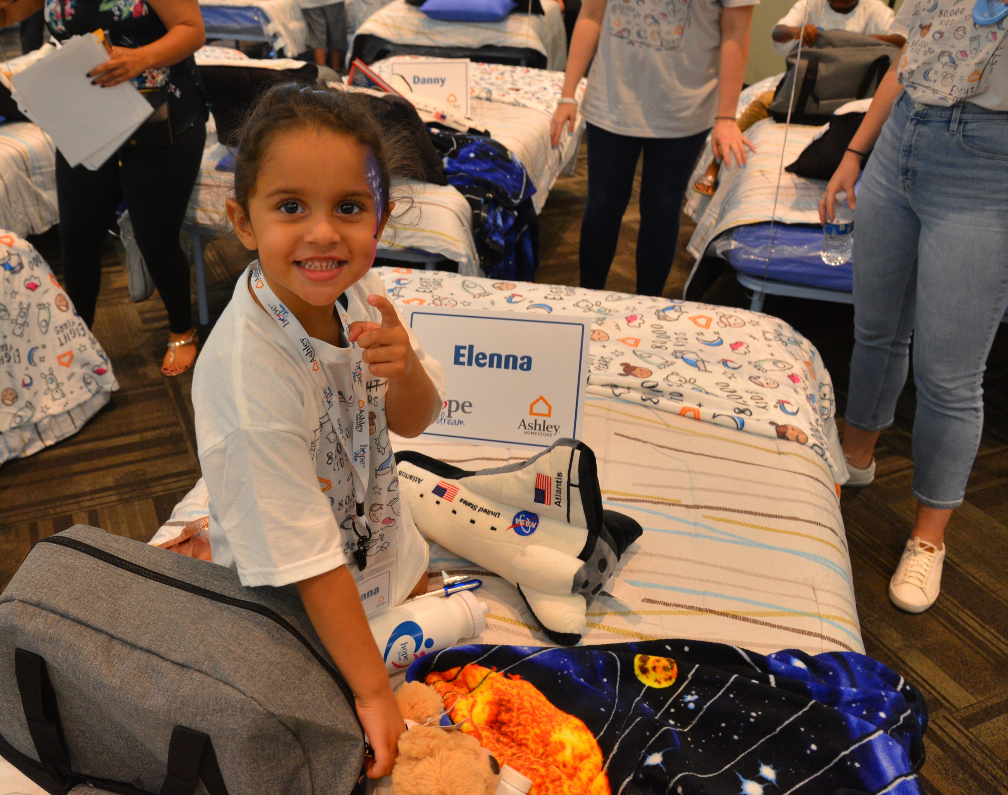 50 students from four Brevard schools were invited to Kennedy Space Center Visitor Complex Friday afternoon for the Ashley HomeStore’s national “Hope to Dream” program to surprise 50 children an afternoon at the Kennedy Space Center Visitor Complex, followed by a mass bed reveal, where kids will receive their very own bed. Children will receive a twin mattress, bed frame, pillow, comforter, mattress protector, swag bag and teddy bear. These children do not have their own bed, they either share with their parent or siblings, sleep on the sofa or on the floor. Ashley's HomeStore Hope to Dream program has given out 90,000 beds since 2010. 