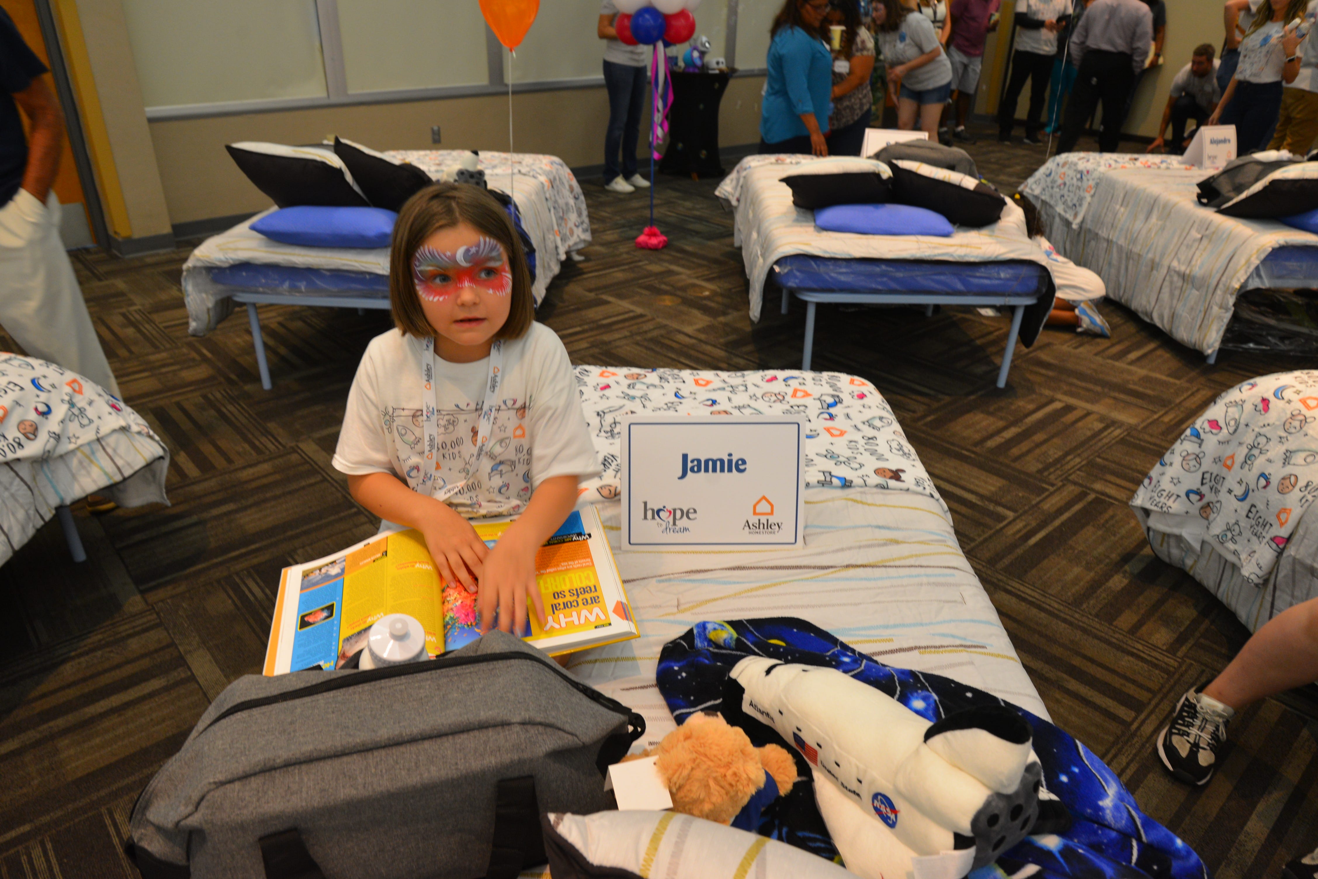50 students from four Brevard schools were invited to Kennedy Space Center Visitor Complex Friday afternoon for the Ashley HomeStoreÕs national ÒHope to DreamÓ program to surprise 50 children an afternoon at the Kennedy Space Center Visitor Complex, followed by a mass bed reveal, where kids will receive their very own bed. Children will receive a twin mattress, bed frame, pillow, comforter, mattress protector, swag bag and teddy bear. These children do not have their own bed, they either share with their parent or siblings, sleep on the sofa or on the floor. Ashley's HomeStore Hope to Dream program has given out 90,000 beds since 2010. 