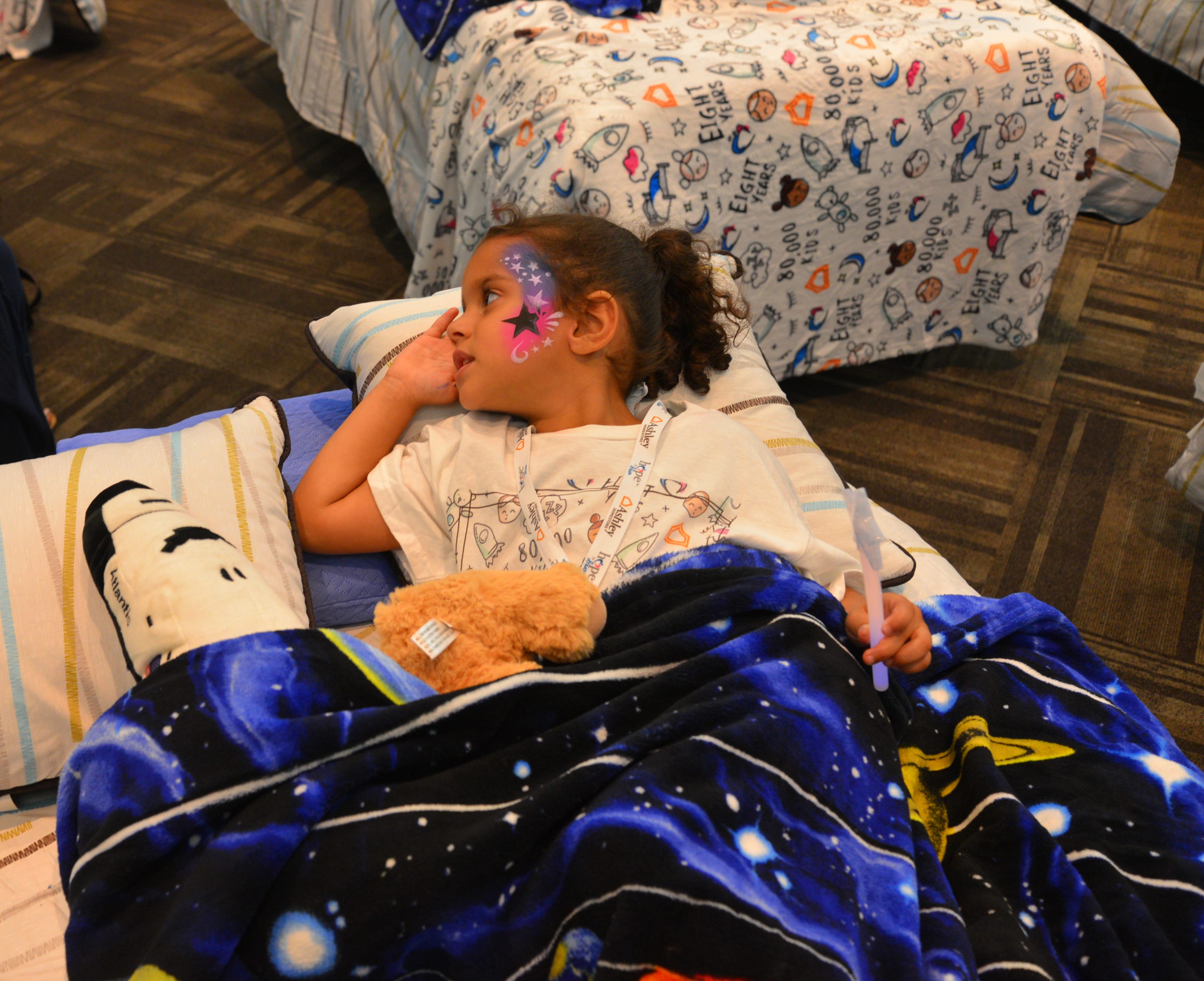 50 students from four Brevard schools were invited to Kennedy Space Center Visitor Complex Friday afternoon for the Ashley HomeStore’s national “Hope to Dream” program to surprise 50 children an afternoon at the Kennedy Space Center Visitor Complex, followed by a mass bed reveal, where kids will receive their very own bed. Children will receive a twin mattress, bed frame, pillow, comforter, mattress protector, swag bag and teddy bear. These children do not have their own bed, they either share with their parent or siblings, sleep on the sofa or on the floor. Ashley's HomeStore Hope to Dream program has given out 90,000 beds since 2010. 