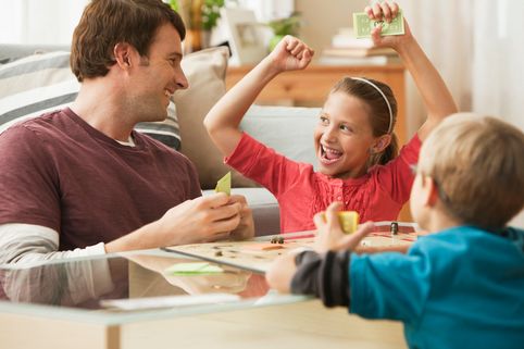 Parents play board game with children