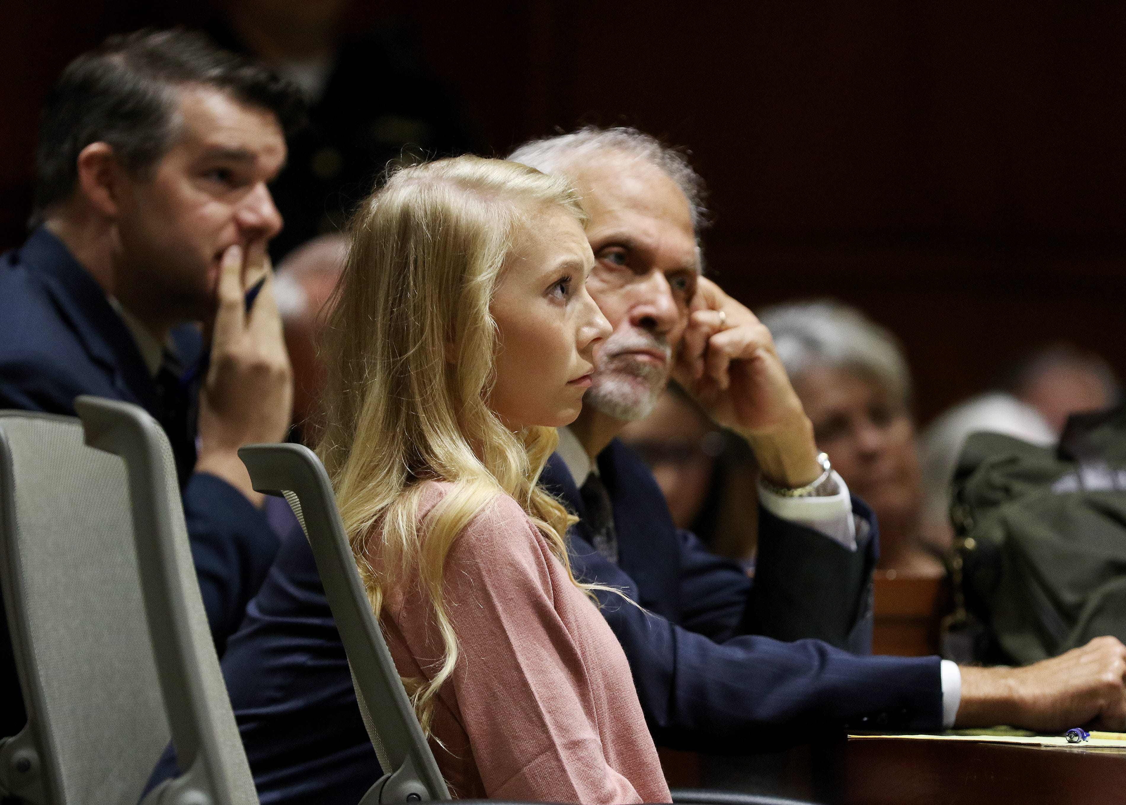 Brooke "Skylar" Richardson, sits with attorneys, Charlie H. Rittgers and Neal Schuett, background, as her other attorney Charlie M. Rittgers makes a statement to the potential jurors at the Warren County Courthouse Tuesday, September 3, 2019. Richardson, 20, is accused of killing and burying her baby in the backyard of her Carlisle home. Richardson is charged with aggravated murder, involuntary manslaughter, gross abuse of a corpse, tampering with evidence and child endangerment in the death of her newborn infant.