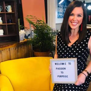a woman sitting at a table with a laptop and smiling at the camera: the eager teacher Sarah Hornung