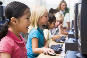 a little girl sitting at a table using a laptop computer: While tablets, laptops, and all kinds of educational software are being implemented in classrooms across the country, some Americans simply can’t afford that kind of technology. Teachers might not be able to afford to train themselves on how to integrate tech into lesson plans. Students (and their families) might not have computers at home to keep up. School districts might not be able to foot the bill of a mass technology distribution program. Whatever the situation—and, sometimes, it’s a combination of all three—the high cost can prove to be an insurmountable barrier for incorporating technology into education.What’s more, The Edvocate, an organization devoted to education policy, points out that, even if students are provided with equipment—say, a personal laptop for schoolwork—not all students have access to the internet once they leave the building. In one Wisconsin school district The Edvocate surveyed, only 78 percent of the district’s students in the low-income category had access to the internet outside of school.
