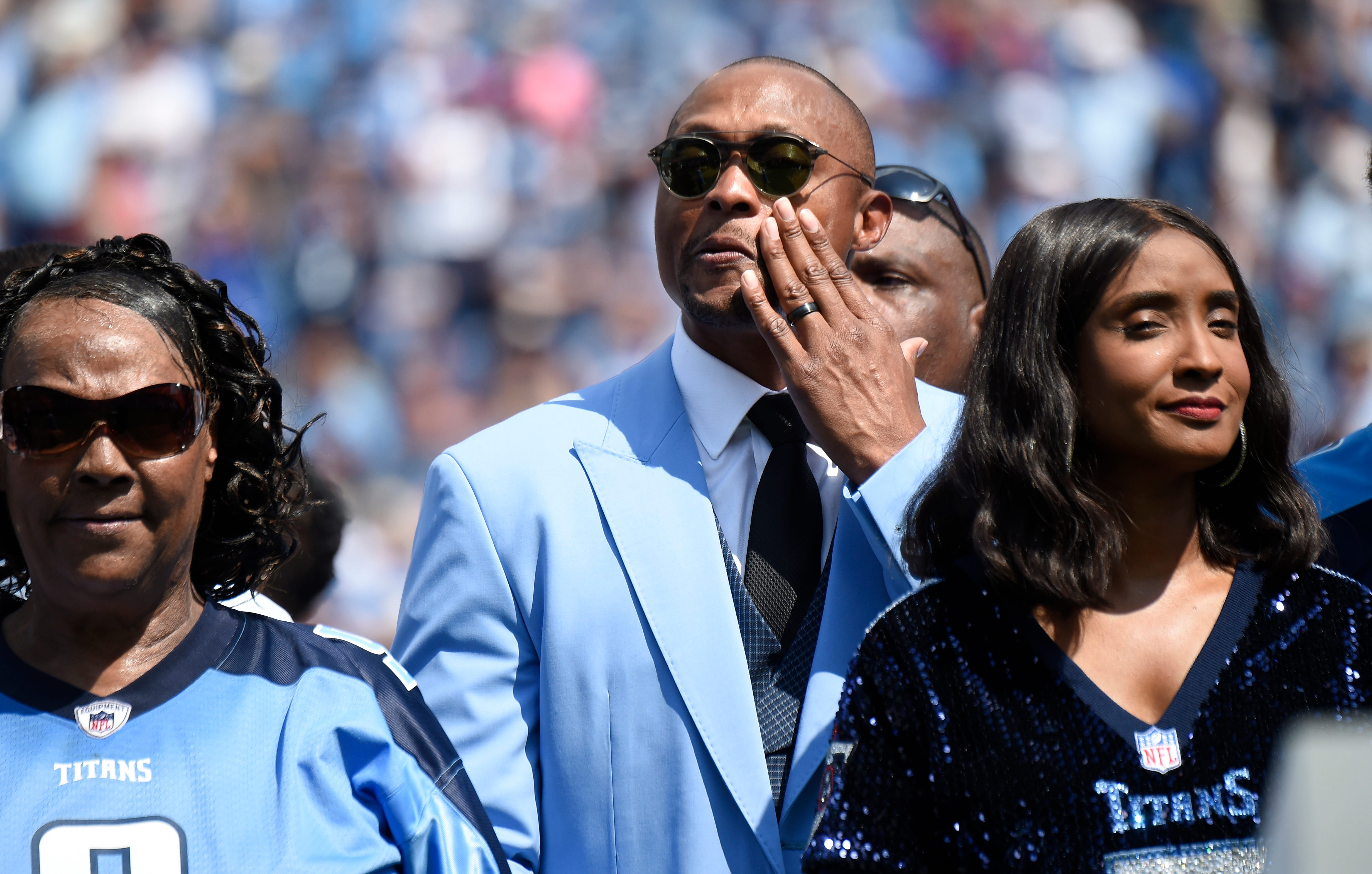 Former Titans great Eddie George gets emotional surrounded by Lucille McNair and Mechelle McNair, mother and widow of the late Steve McNair, as their jersey numbers are retired during halftime at Nissan Stadium Sunday, Sept. 15, 2019 in Nashville, Tenn. 