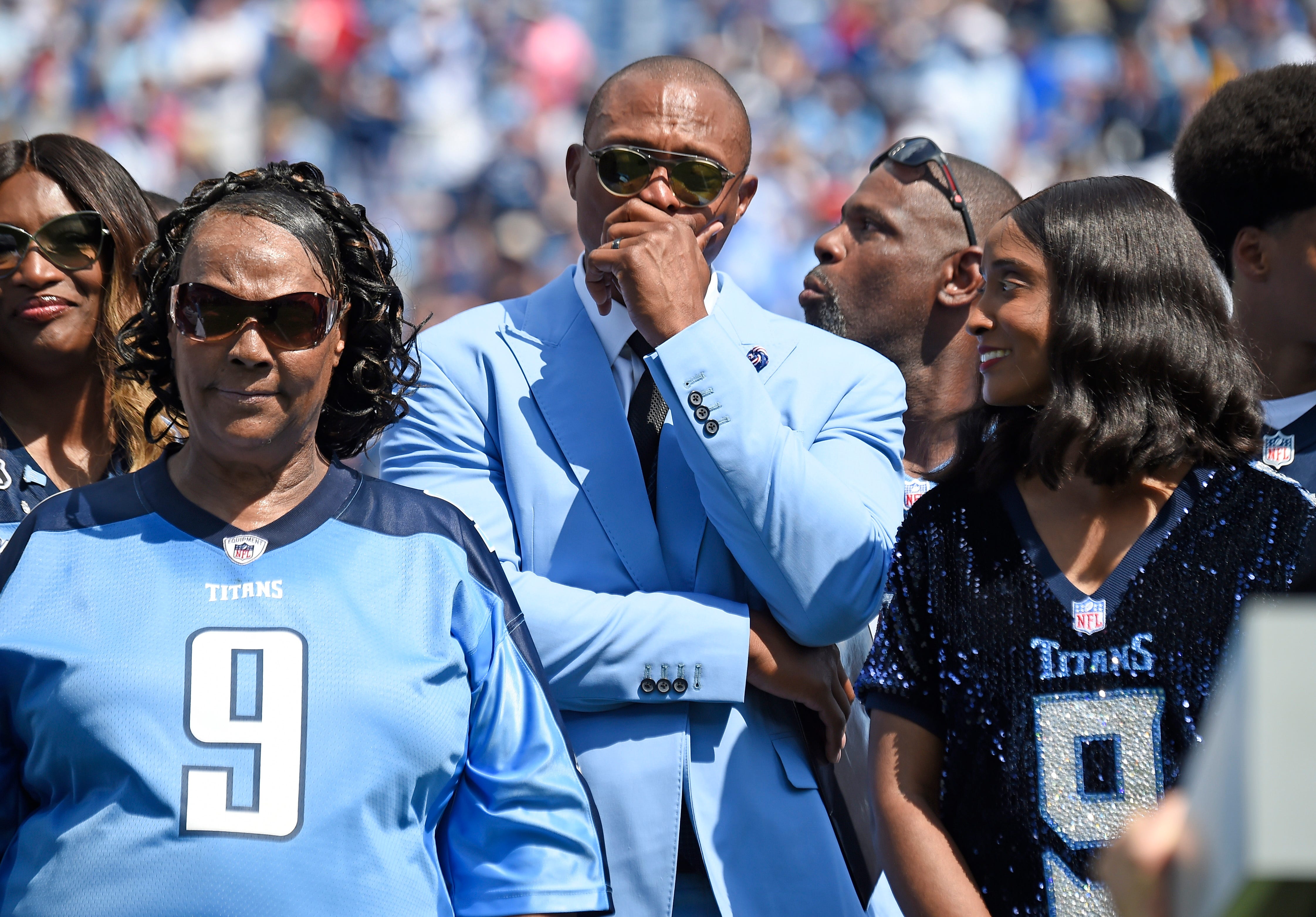 Former Titans great Eddie George gets emotional surrounded by Lucille McNair and Mechelle McNair, mother and widow of the late Steve McNair, as their jersey numbers are retired during halftime at Nissan Stadium Sunday, Sept. 15, 2019 in Nashville, Tenn. 