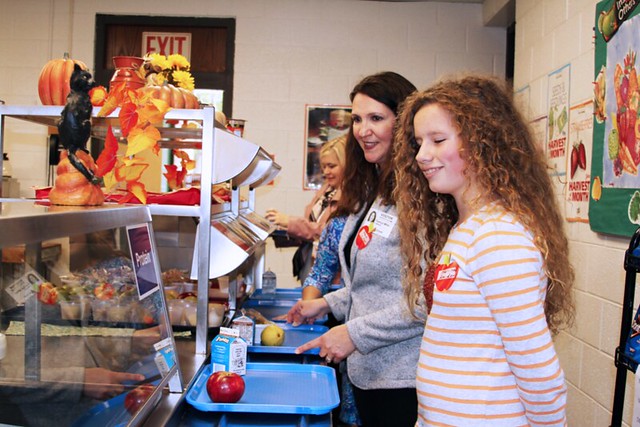 Administrator Pam Miller with students at the lunchline