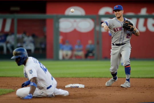 New York Mets second baseman Joe Panik (2) throws to first for the double play hit into by Kansas City Royals' Cheslor Cuthbert, after forcing out Jorge Soler (12) out at second during the fourth inning of a baseball game Saturday, Aug. 17, 2019, in Kansas City, Mo.