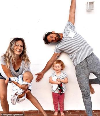 a group of people posing for the camera: Lawrence (right) says that his wife (left) understands that his training is essential for him to be at his best both professionally and personally. Pictured: with his two children