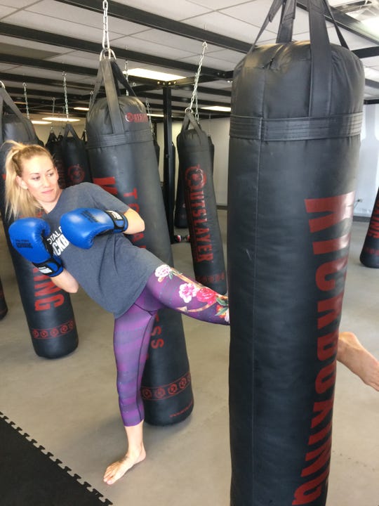 Instructor Misty Weimer of Knoxville shows the proper technique for a kick.