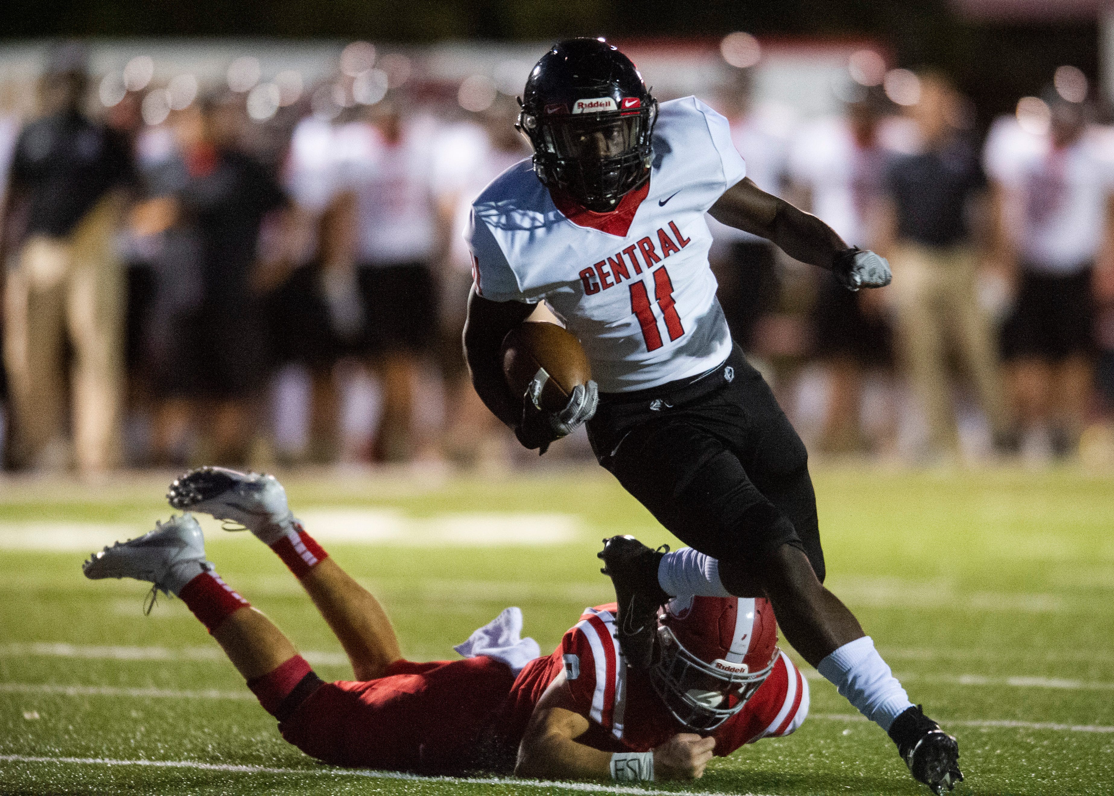 Central's Jason Merritts (11) dodges Halls' Jake Parris (8) during the Halls and Central high school football game on Friday, October 4, 2019 at Halls High School.
