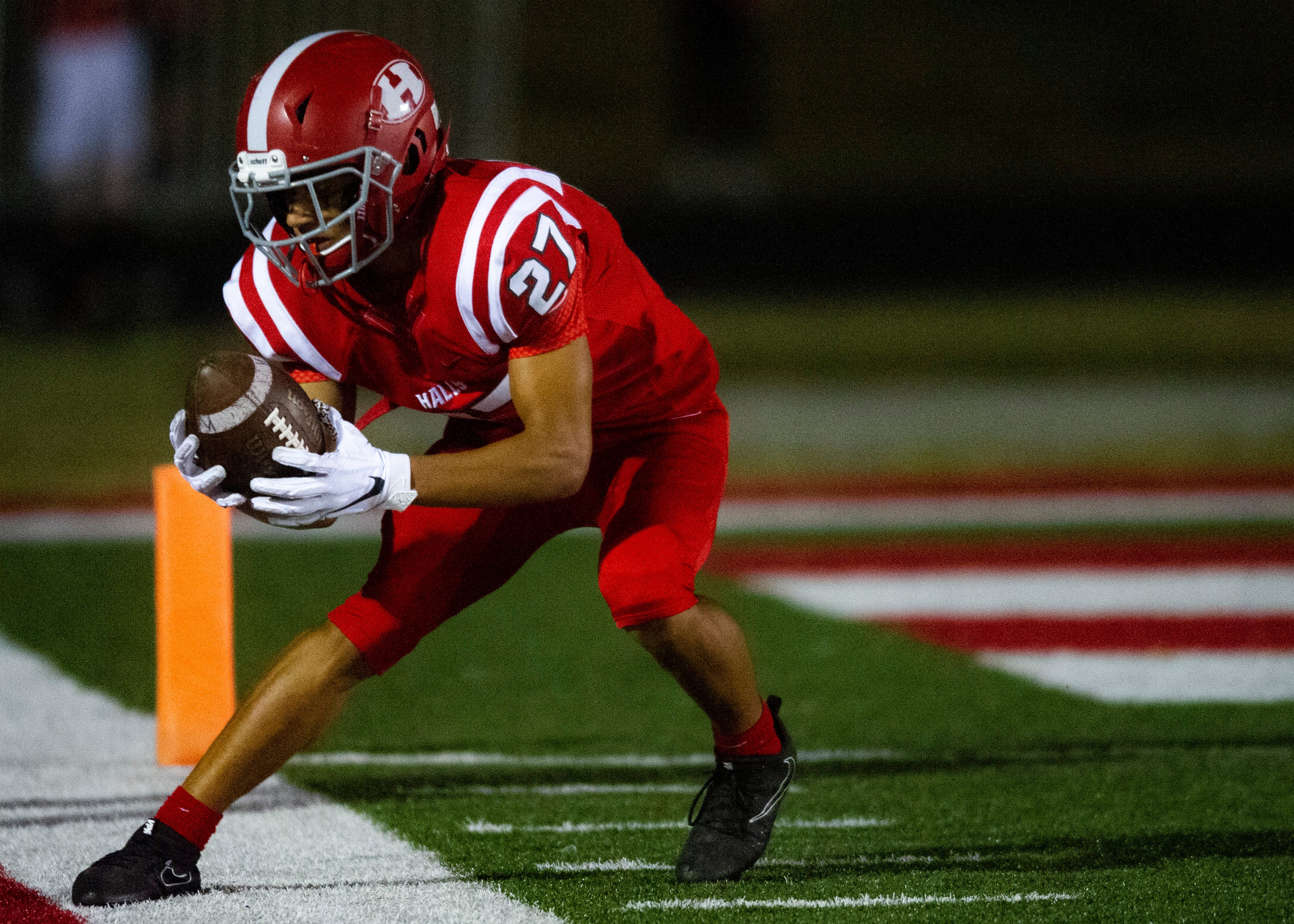 Halls' Tae Rucker (27) attempts to keep the ball in play during the Halls and Central high school football game on Friday, October 4, 2019 at Halls High School.