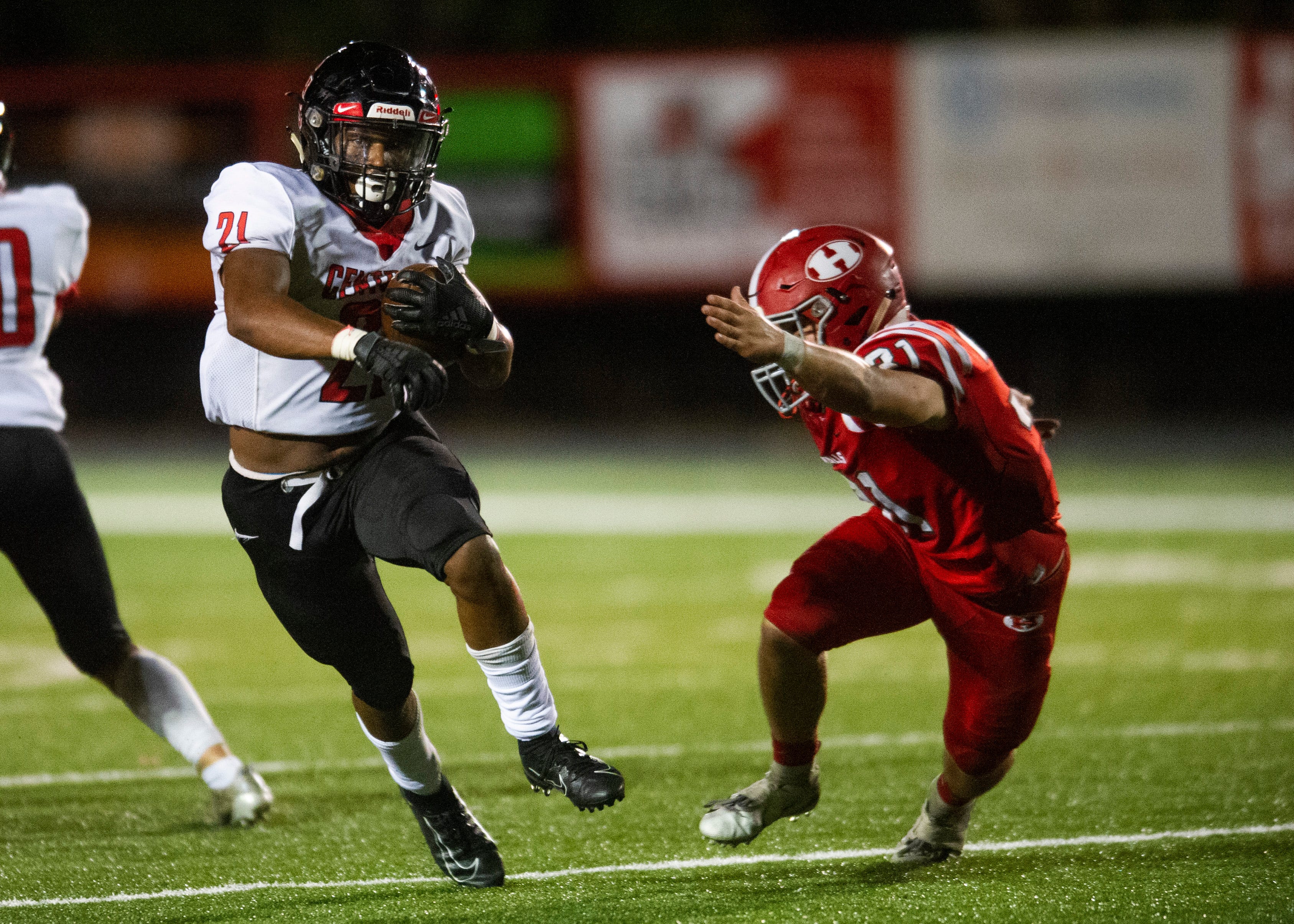 Central's Makhi Anderson (21) runs past Halls' Brett McMahan (31) during the Halls and Central high school football game on Friday, October 4, 2019 at Halls High School.