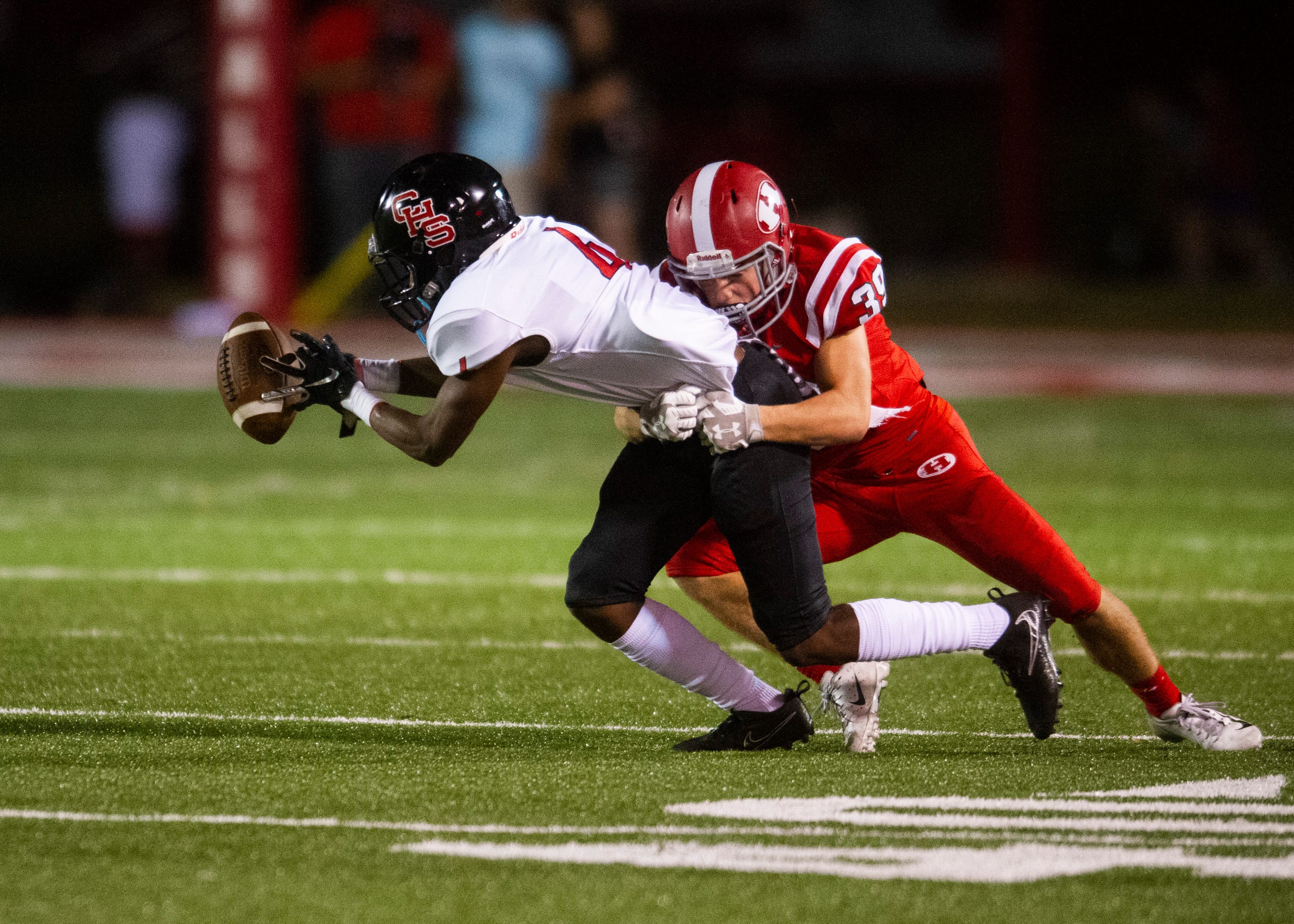 Central's Jonathan Mynatt (4) holds on to the ball with the tips of his fingers as Halls' Caden Stephens (39) attempts to pull him down during the Halls and Central high school football game on Friday, October 4, 2019 at Halls High School.