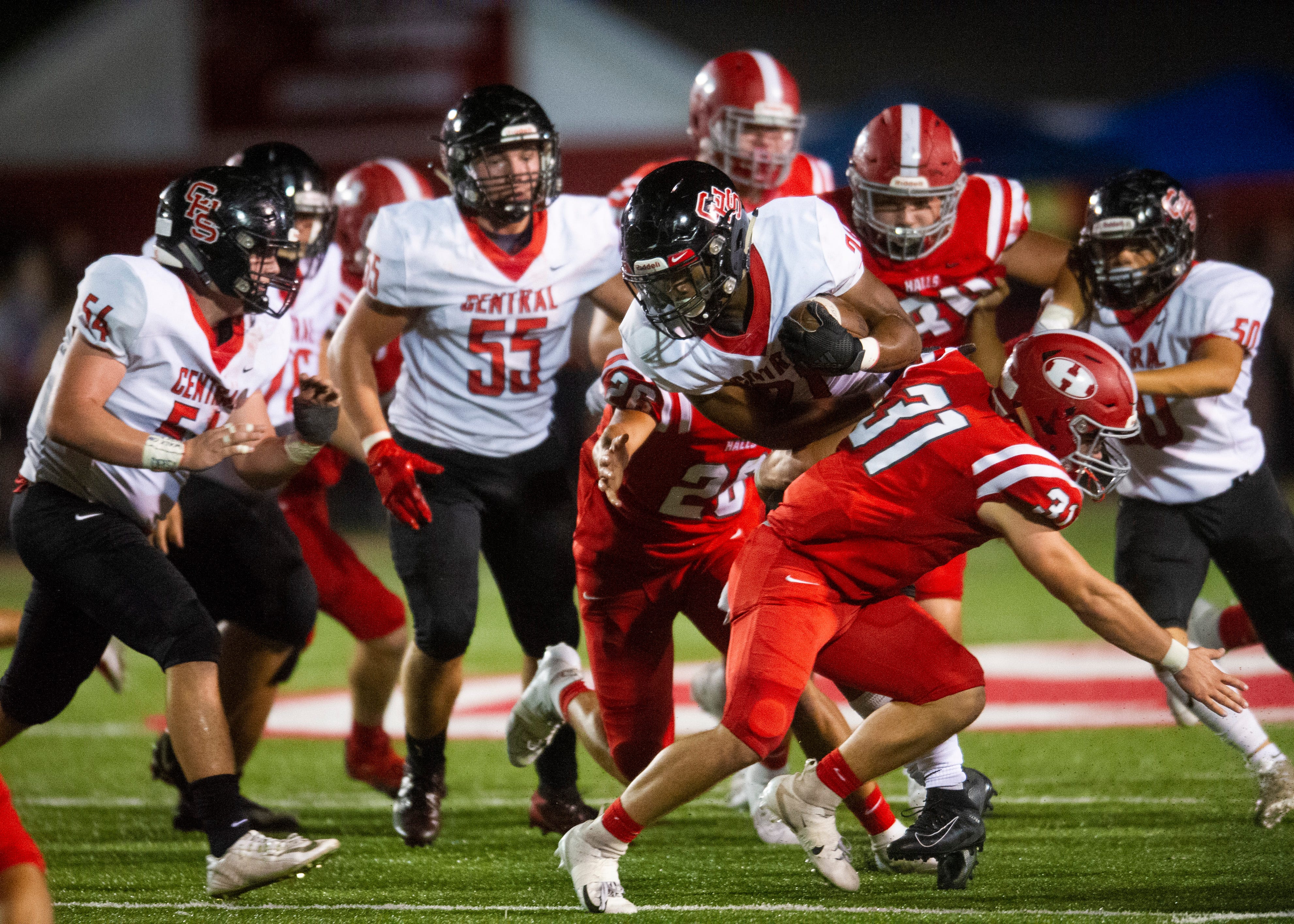 Central's Makhi Anderson (21) attempts to push through Halls' defense during the Halls and Central high school football game on Friday, October 4, 2019 at Halls High School.