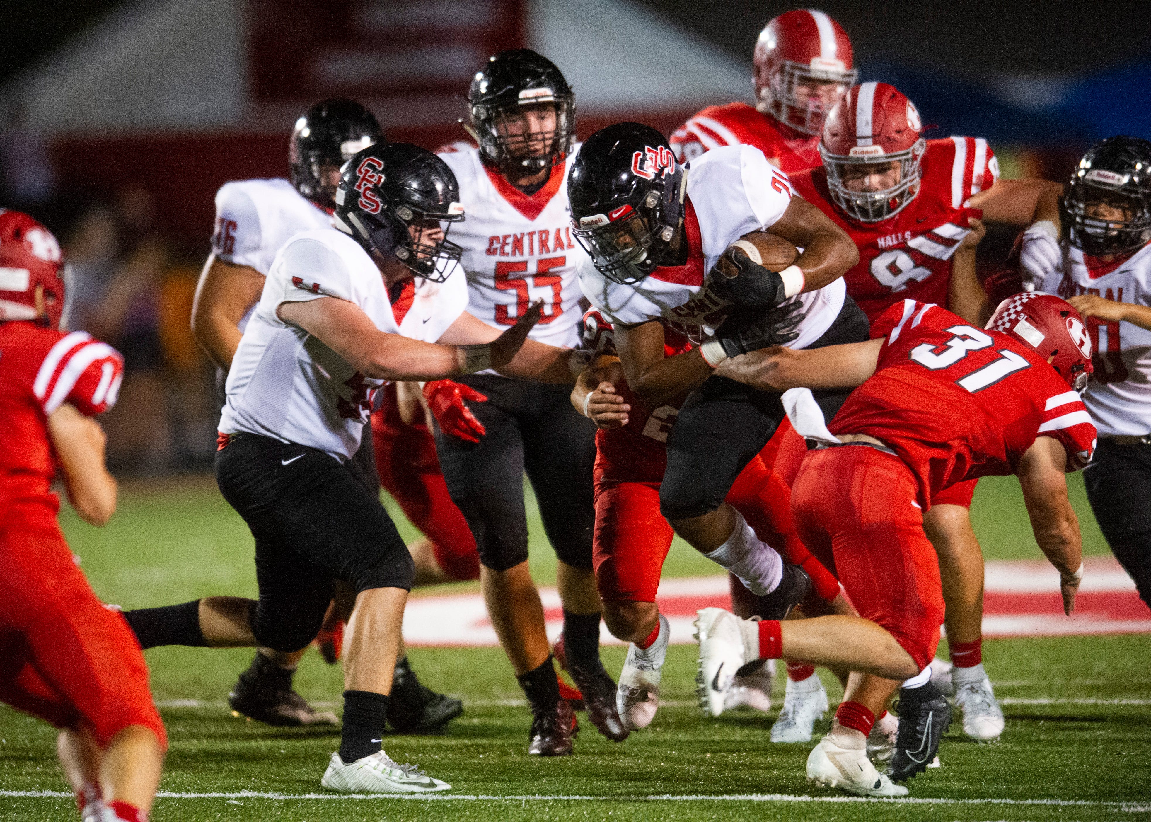 Central's Makhi Anderson (21) attempts to push through Halls' defense during the Halls and Central high school football game on Friday, October 4, 2019 at Halls High School.