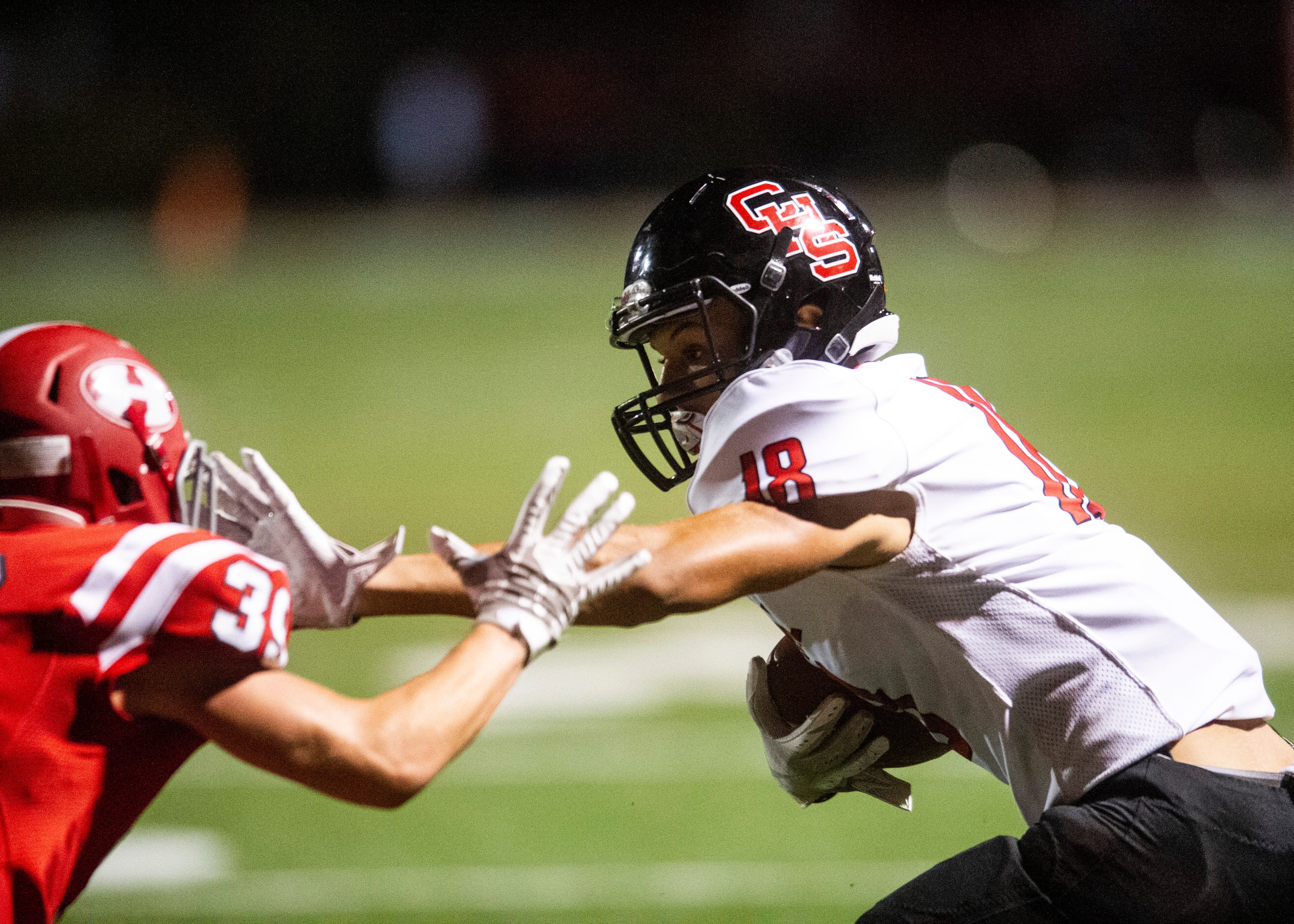 Central's Isaiah Osborne (18) pushes away Halls' Caden Stephens (39) during the Halls and Central high school football game on Friday, October 4, 2019 at Halls High School.