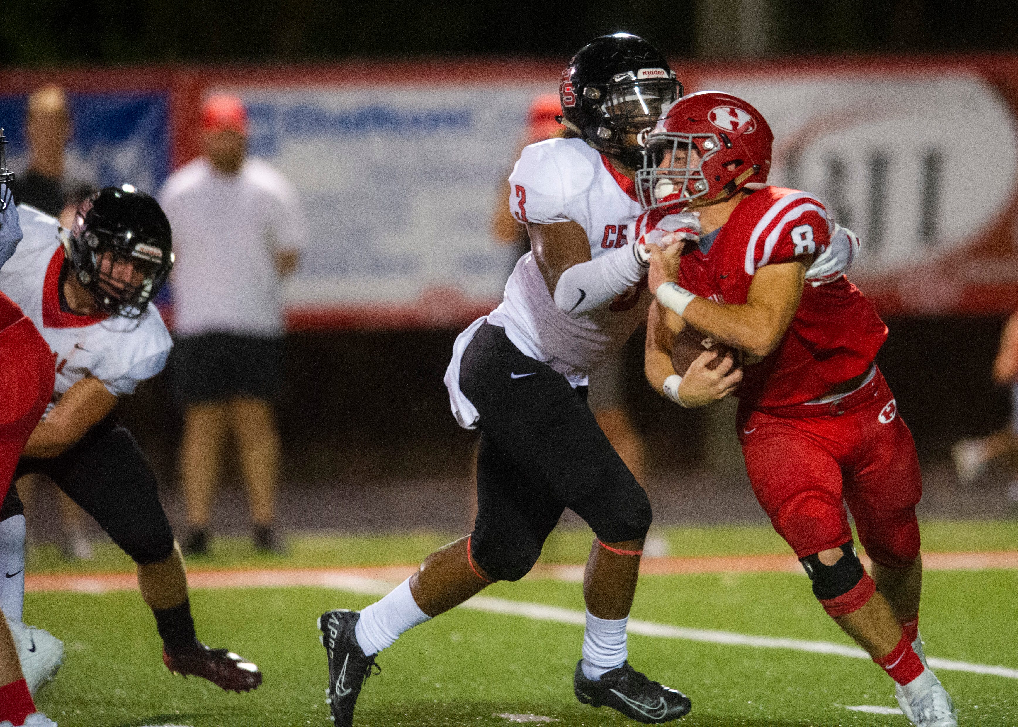 Halls' Jake Parris (8) attempts to escape Central's Eunique Valentine (3) grasp during the Halls and Central high school football game on Friday, October 4, 2019 at Halls High School.