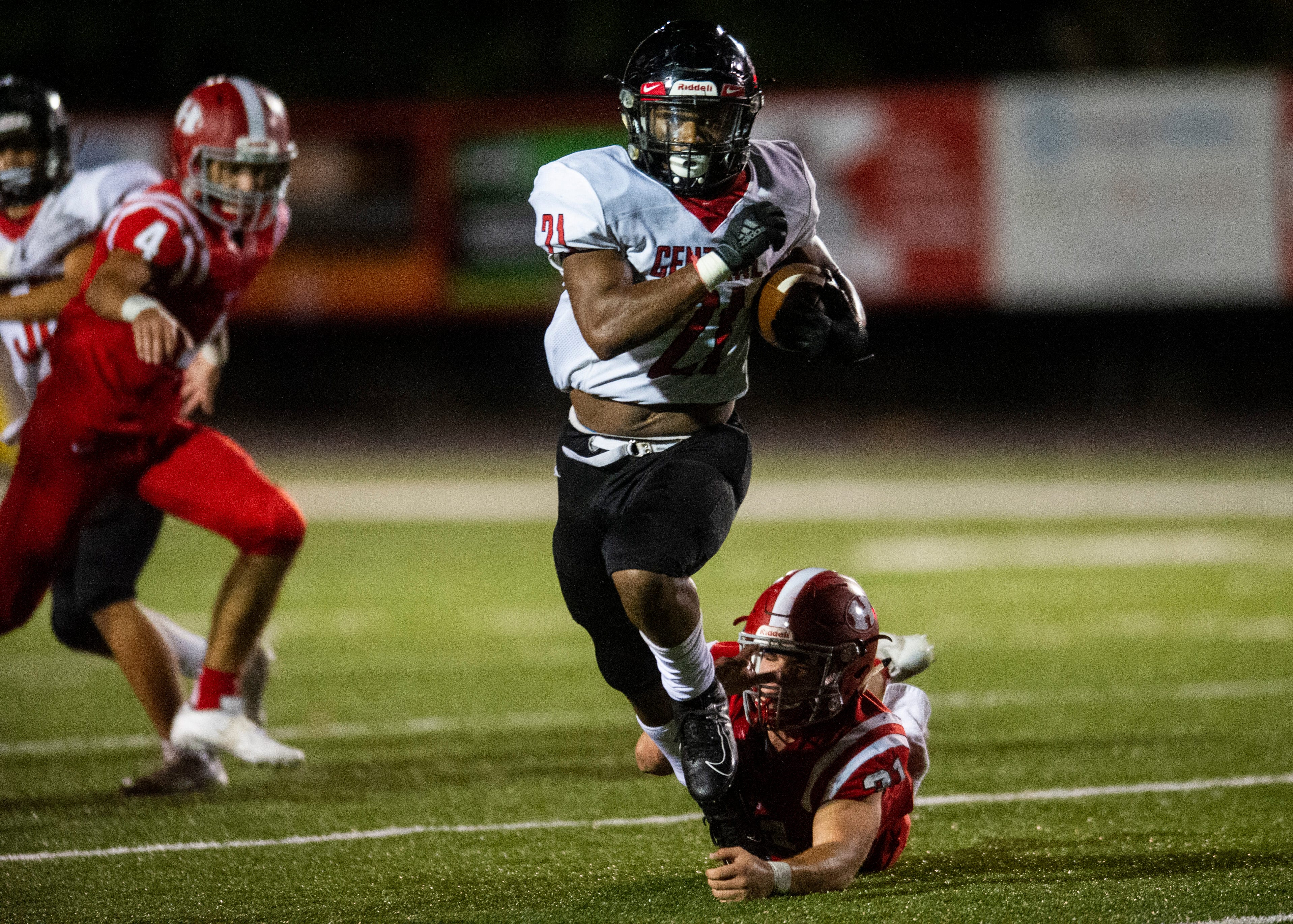 Central's Makhi Anderson (21) runs past Halls' Brett McMahan (31) during the Halls and Central high school football game on Friday, October 4, 2019 at Halls High School.