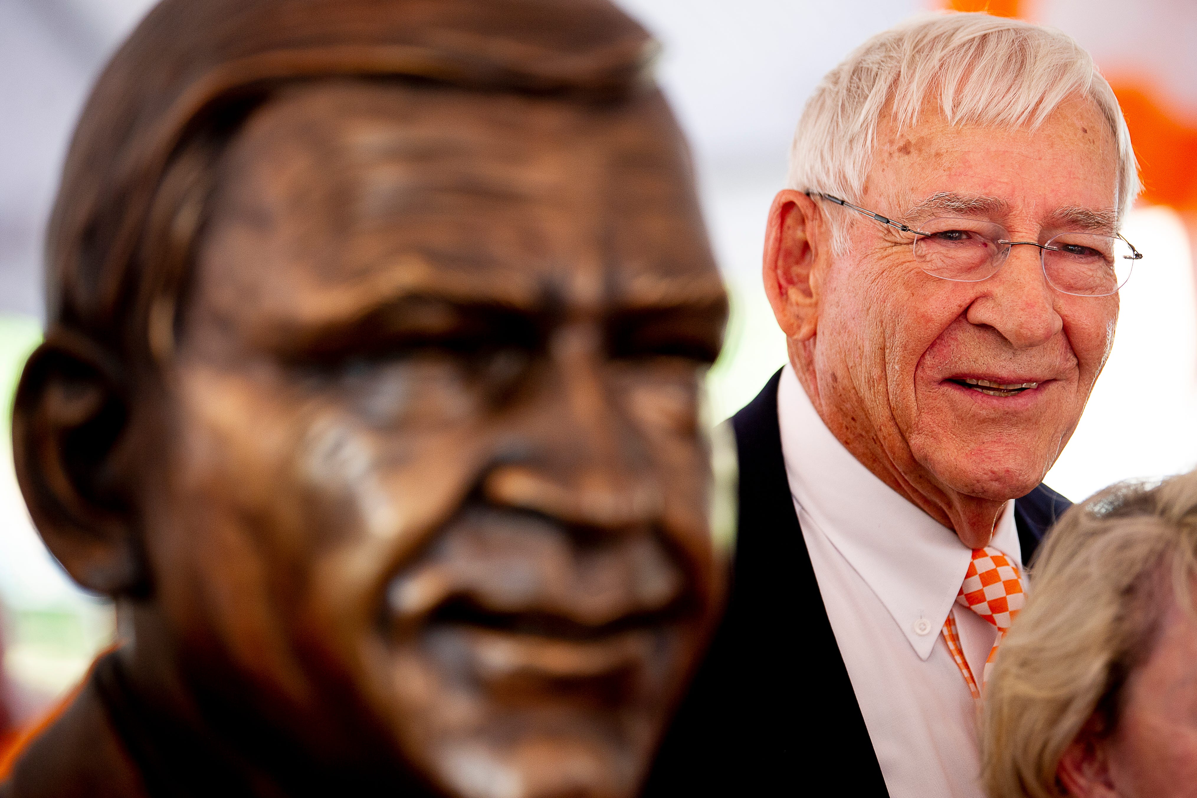 Former Tennessee coach and athletic director Doug Dickey stands beside a newly unveiled bust of him during a dedication ceremony of the Doug Dickey Hall of Fame Plaza at the Neyland-Thompson Sports Complex in Knoxville, Tennessee on Friday, October 4, 2019. Dickey led UT to its second SEC title in 1969 and served as the Vols' Director of Athletics from 1986 to 2003.