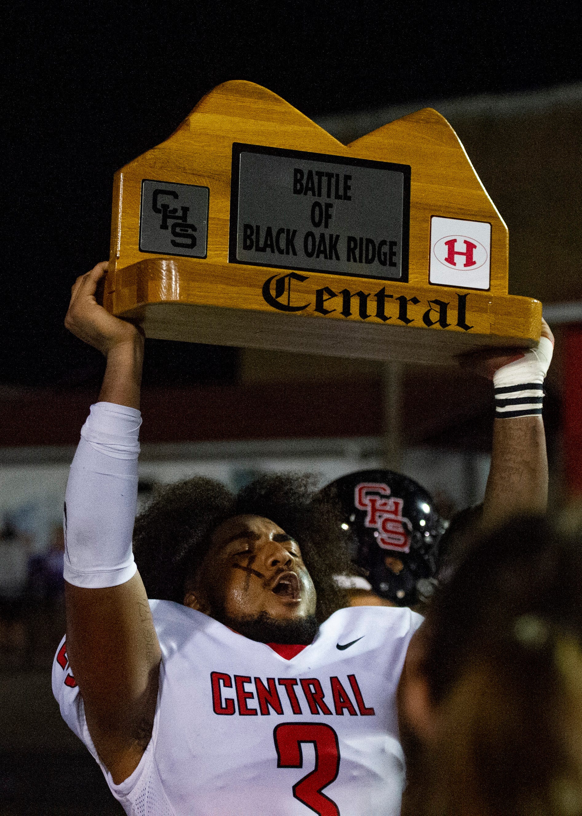Central's Eunique Valentine (3) holds up the "Battle of Black Oak Ridge" rivalry trophy after the Halls and Central high school football game on Friday, October 4, 2019 at Halls High School.