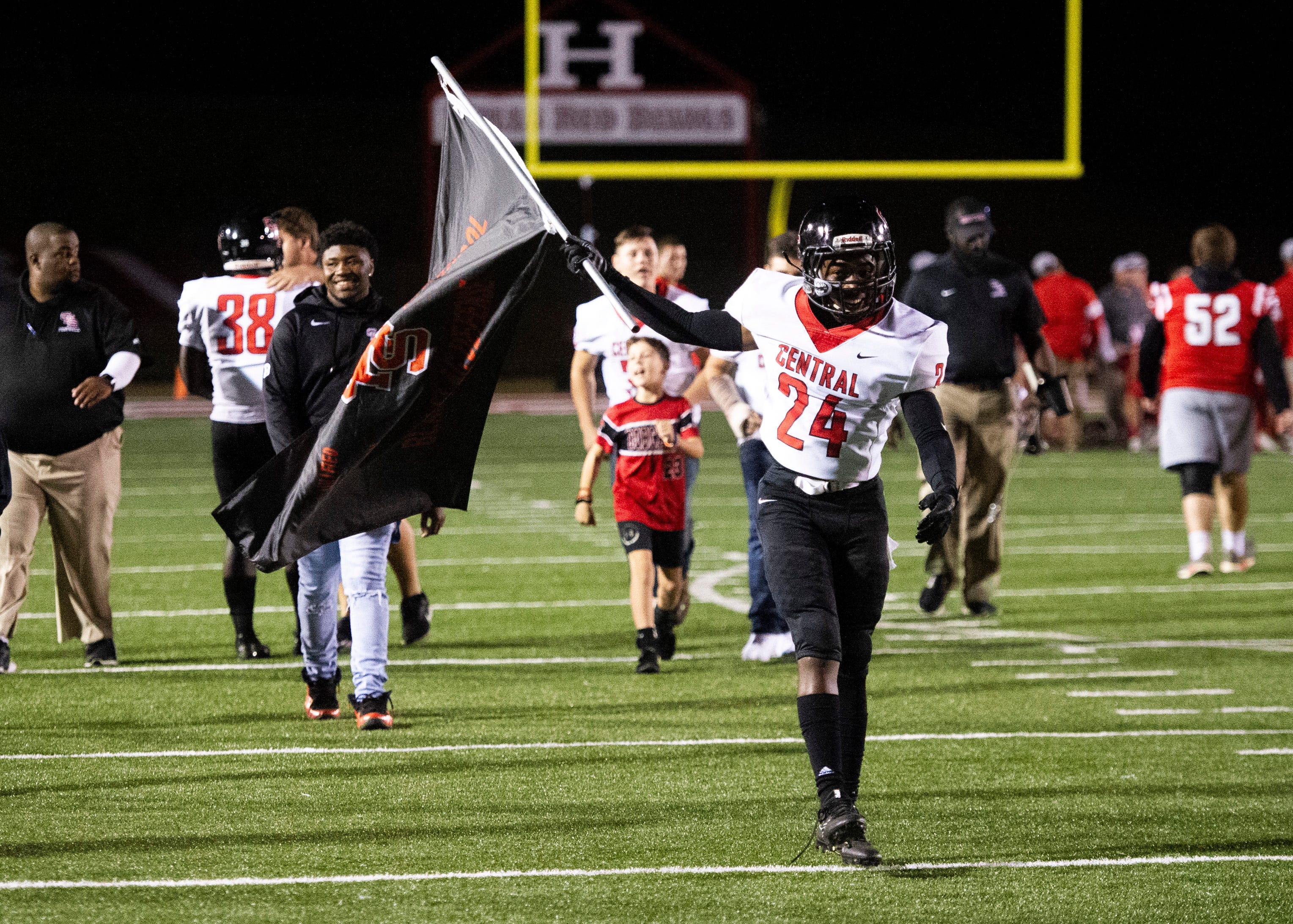 Central's Deontae White (24) runs with the "Black Flag Defense" flag after the Halls and Central high school football game on Friday, October 4, 2019 at Halls High School.