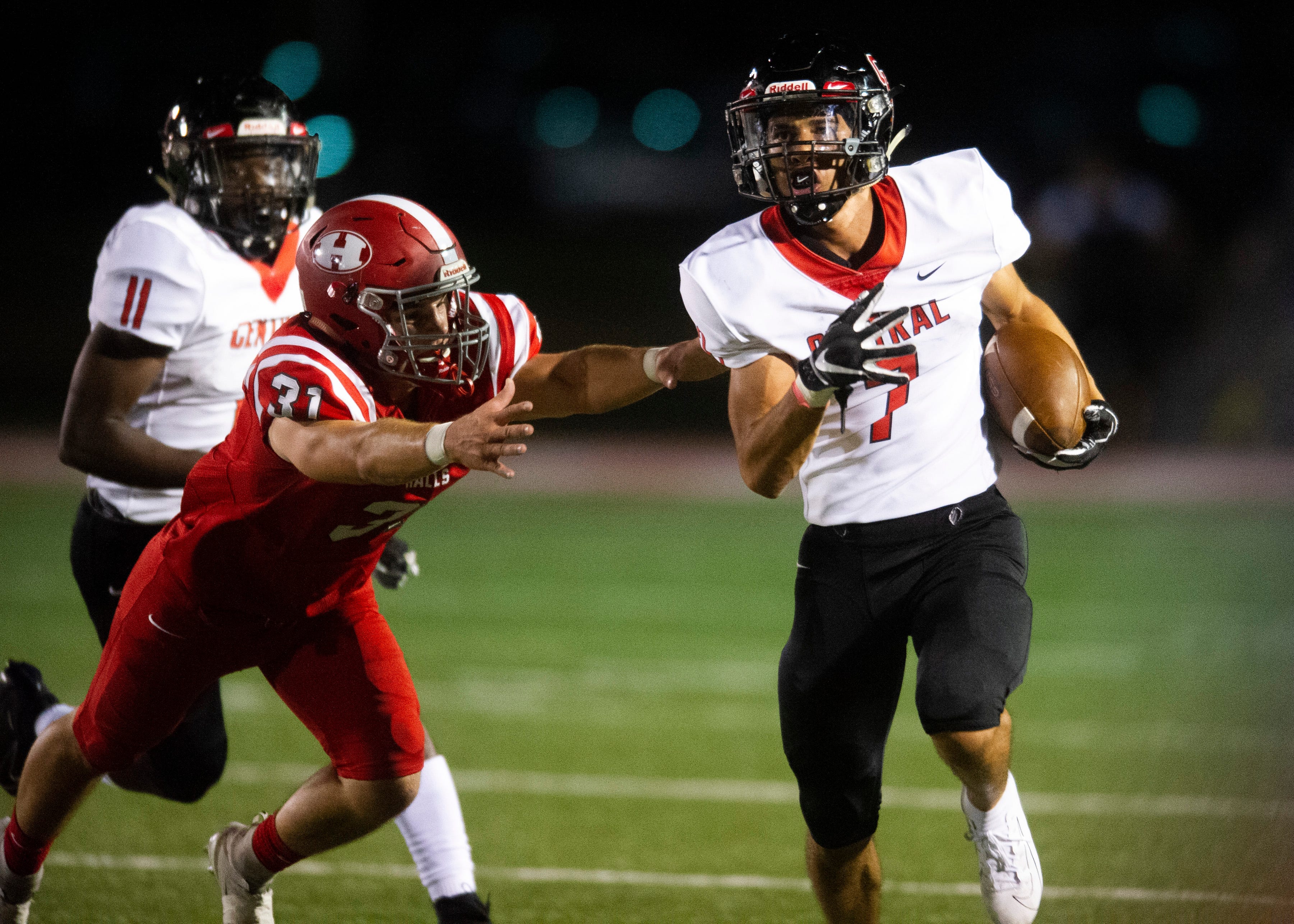 Central's Braden Gaston (7) runs past Halls' Brett McMahan (31) during the Halls and Central high school football game on Friday, October 4, 2019 at Halls High School.