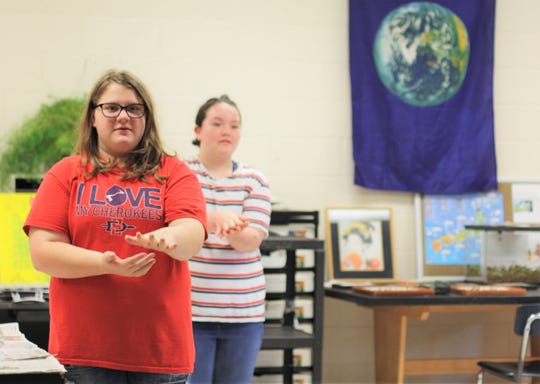 Abigail Hawkins, left, and Abby Pease are playing Janken against their opponents on the other side of the room. It is a Japanese version of rock-paper-scissors. Each says "janken pon!" and throws out their move. 10/1/2019