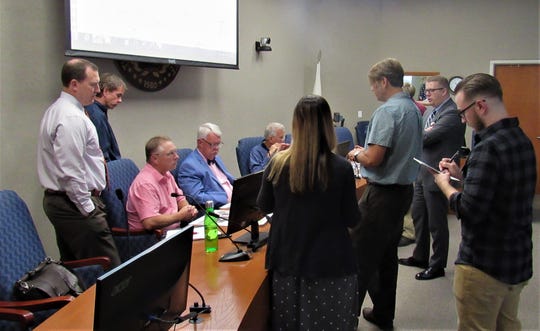 Town staff and aldermen looked over diagrams presented by architects for Admiral’s Landing, the redevelopment project proposed for the old Phillips 66 gas station on Kingston Pike.