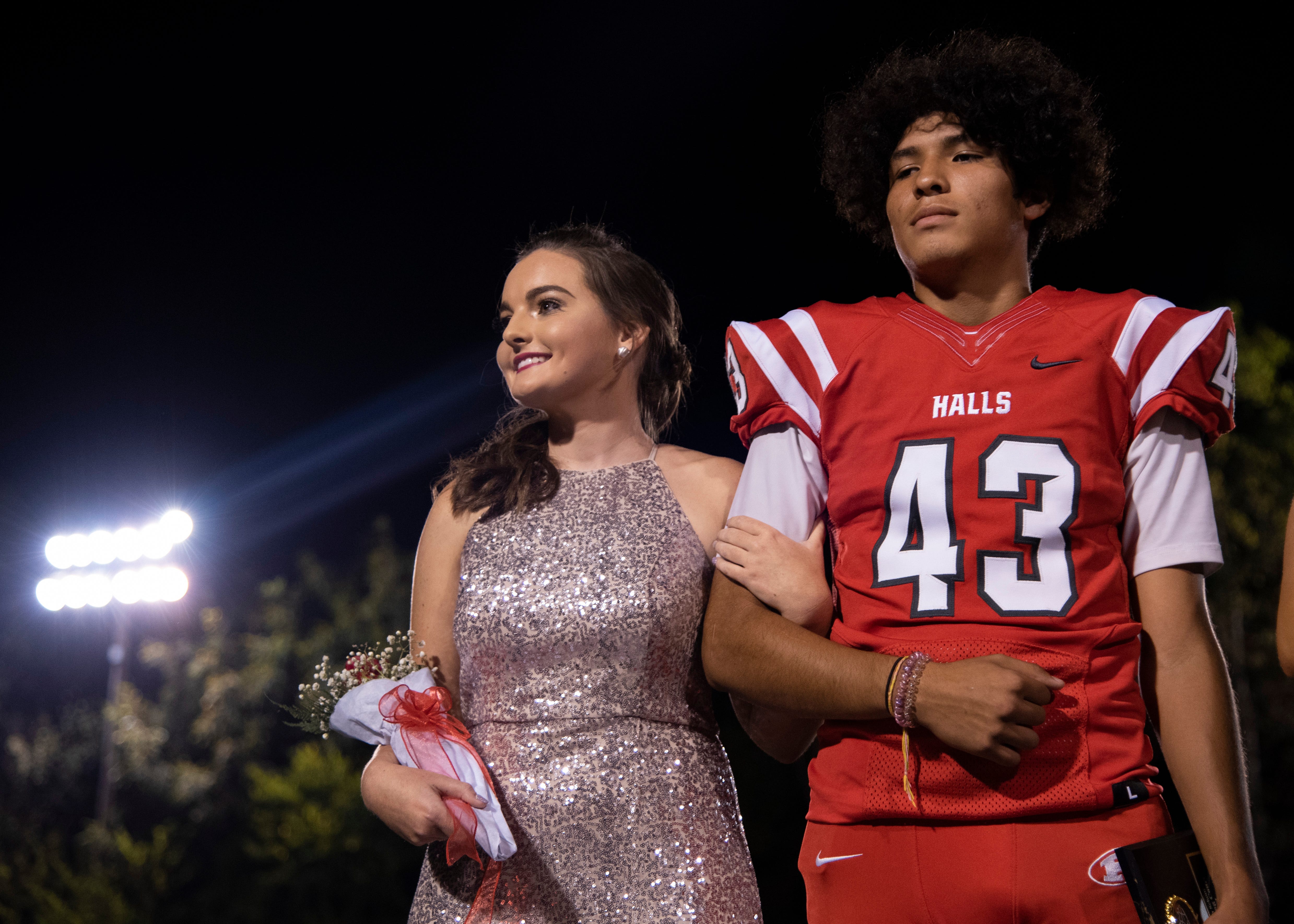 A Halls homecoming court member with Adam Ovalle (43) during the Halls and Central high school football game Friday, Oct. 4, 2019, at Halls High School.