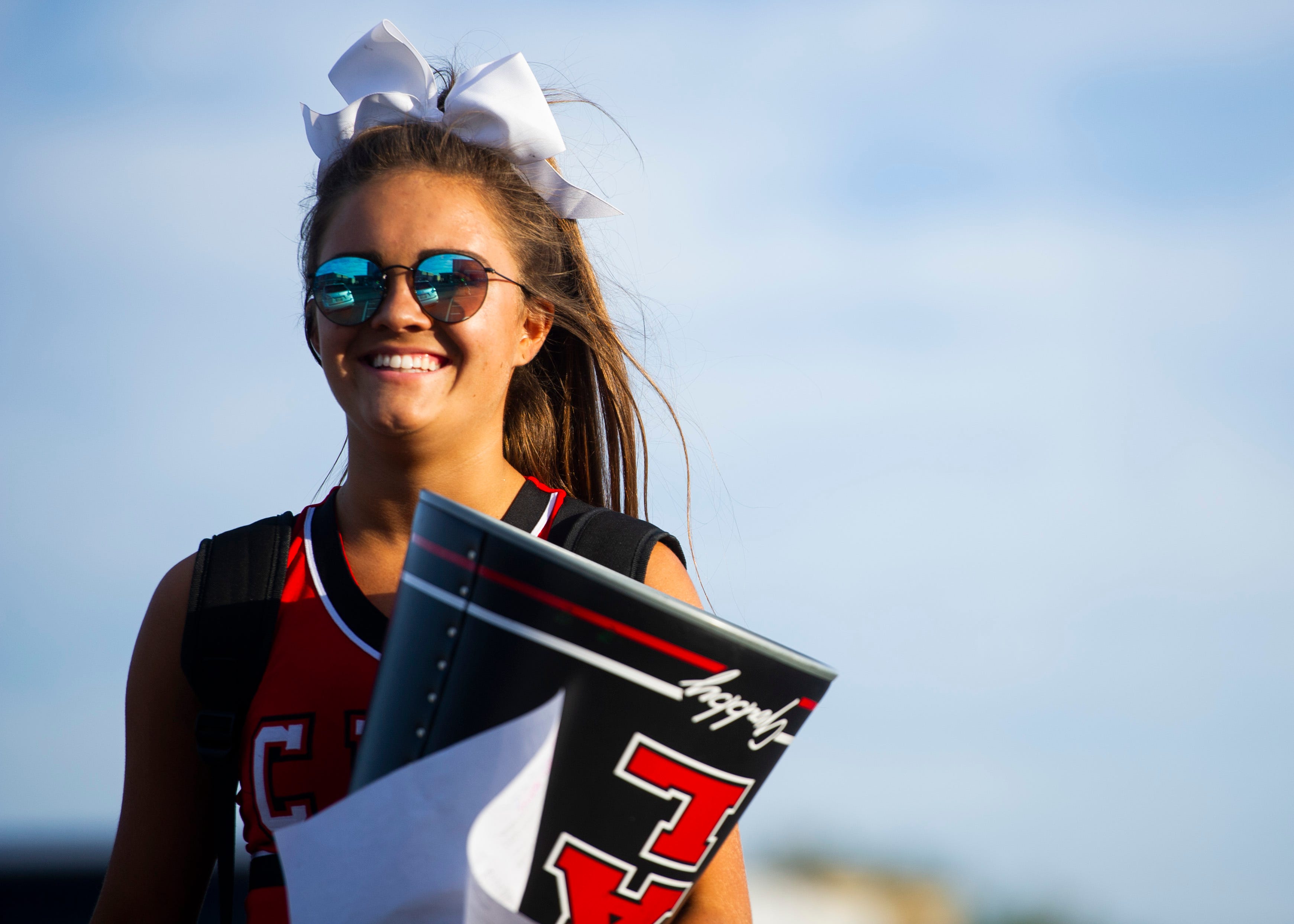 A Central cheerleader walks to Halls' stadium before the Halls and Central high school football game on Friday, October 4, 2019 at Halls High School.