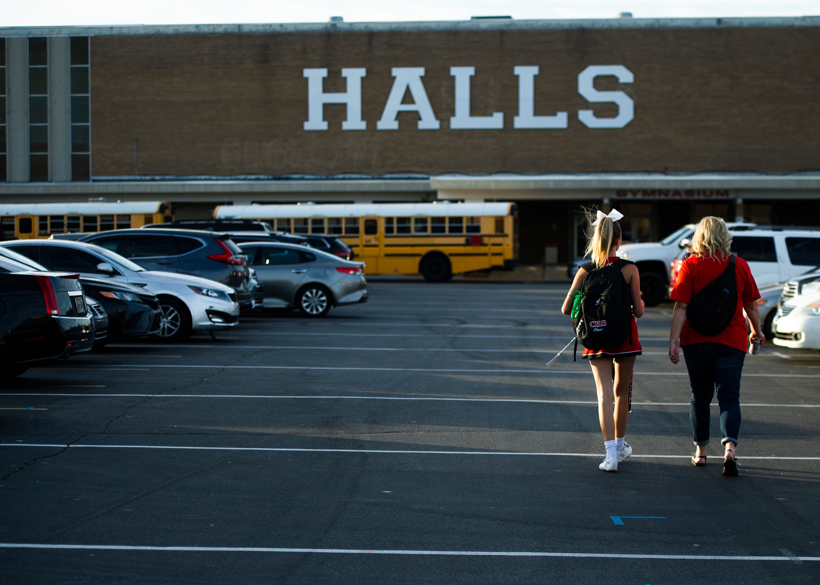 A Central cheerleader walks to the stadium before the Halls and Central high school football game on Friday, October 4, 2019 at Halls High School.
