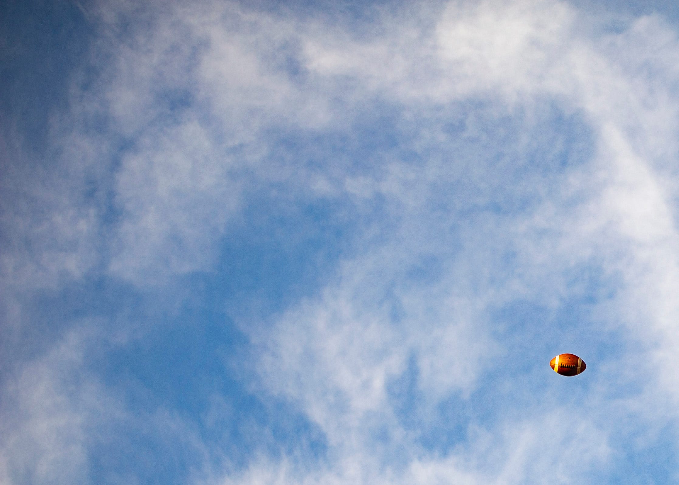 A football flies in the air before the Halls and Central high school football game on Friday, October 4, 2019 at Halls High School.