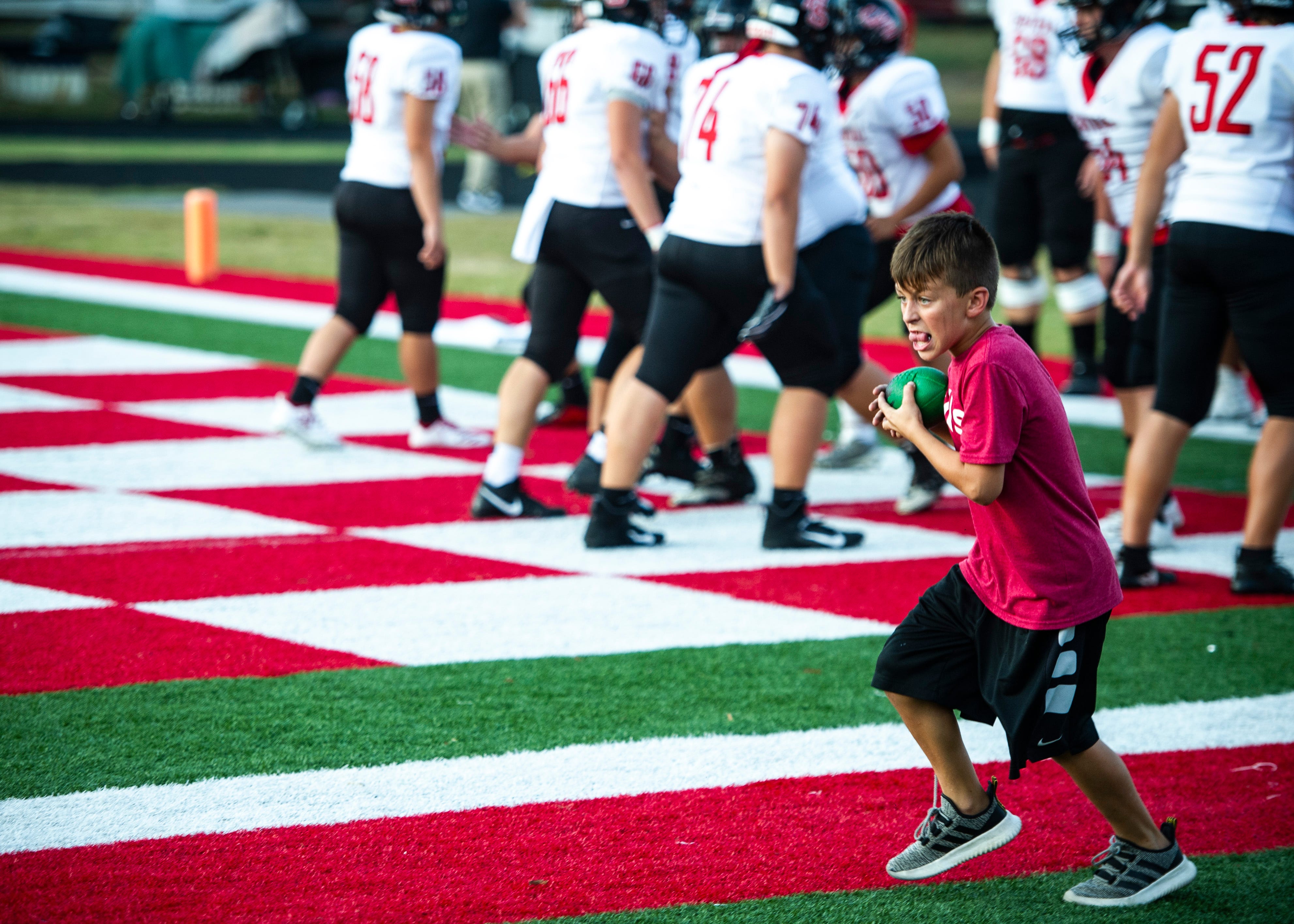 A ball boy runs the ball before the Halls and Central high school football game on Friday, October 4, 2019 at Halls High School.