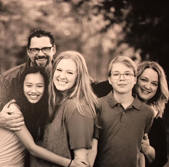 Cara and Christian Finger stand with their children Corinne, 17, Caroline, 18, and Christian, 14. Cara Finger launched the nonprofit My Bag My Story last week to help foster children.