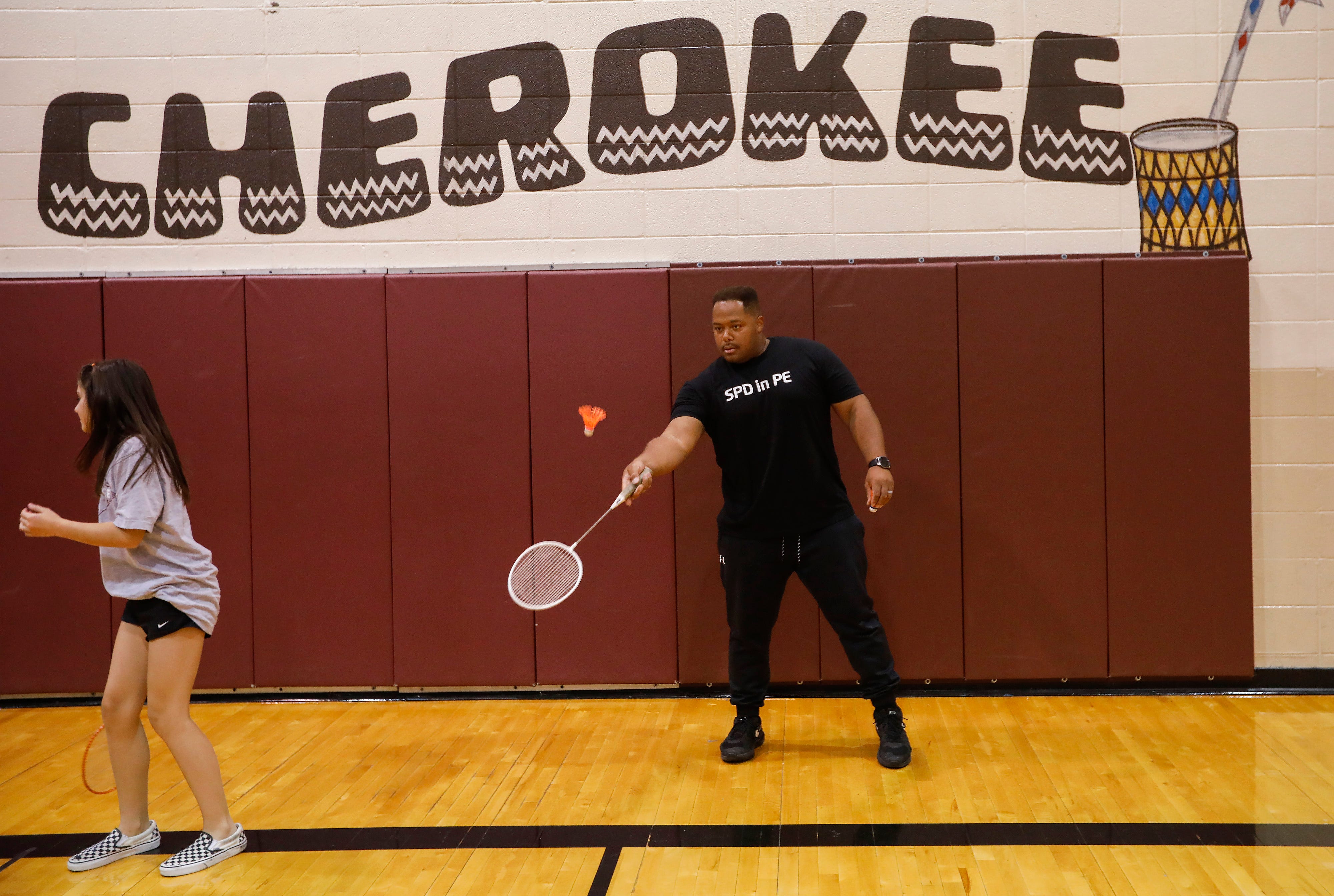 Springfield Police Officer Darrell Barge plays badminton with seventh-grade students at Cherokee Middle School as part of the SPD in PE program Wednesday.