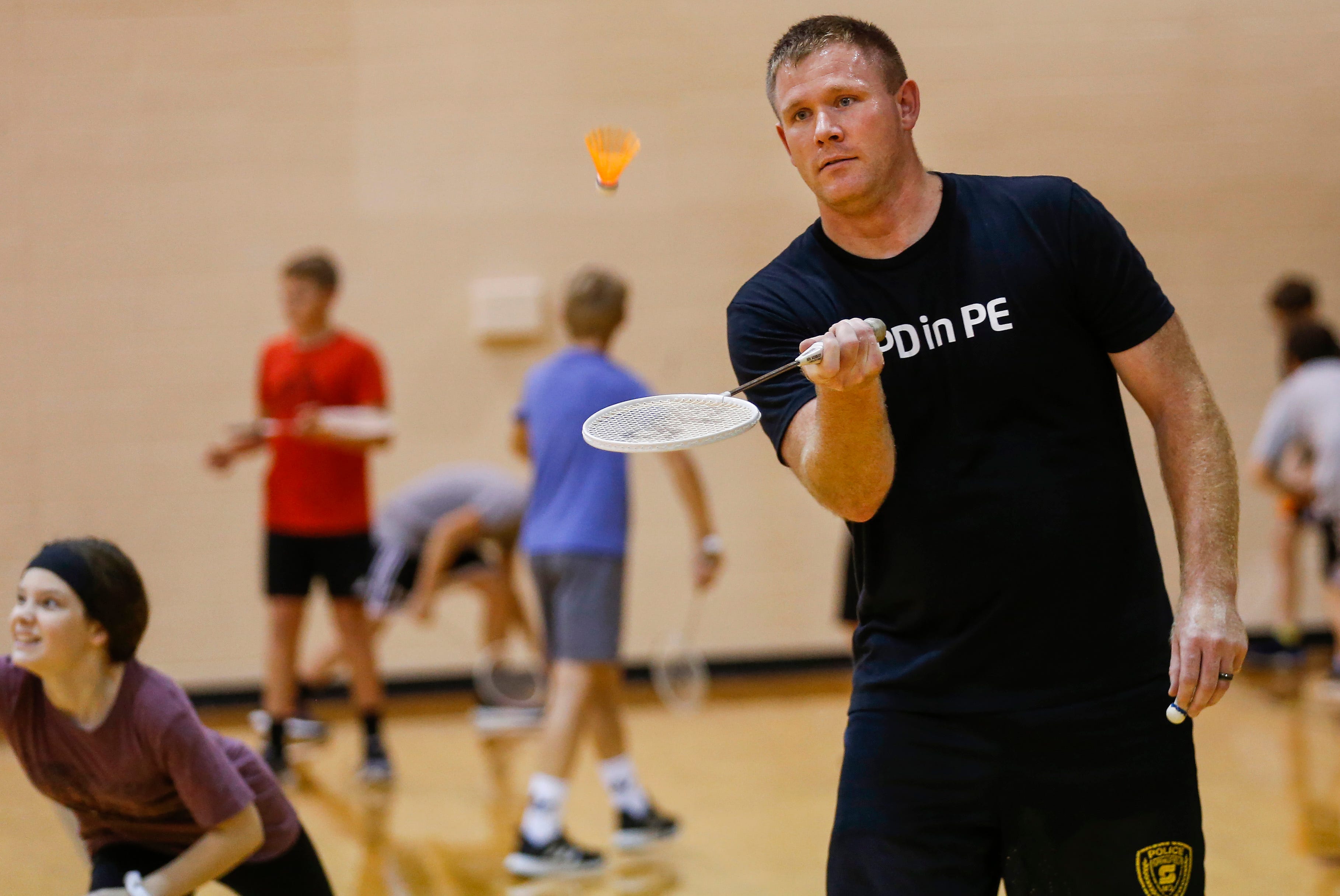 Springfield Police Officer Aaron Cottengim plays badminton with seventh-grade students at Cherokee Middle School as part of the SPD in PE program on Wednesday, Oct. 16, 2019.